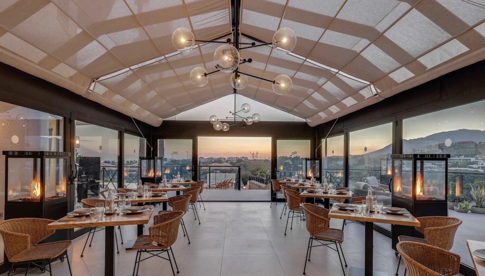 Covered terrace dining area with mountain and sunset views