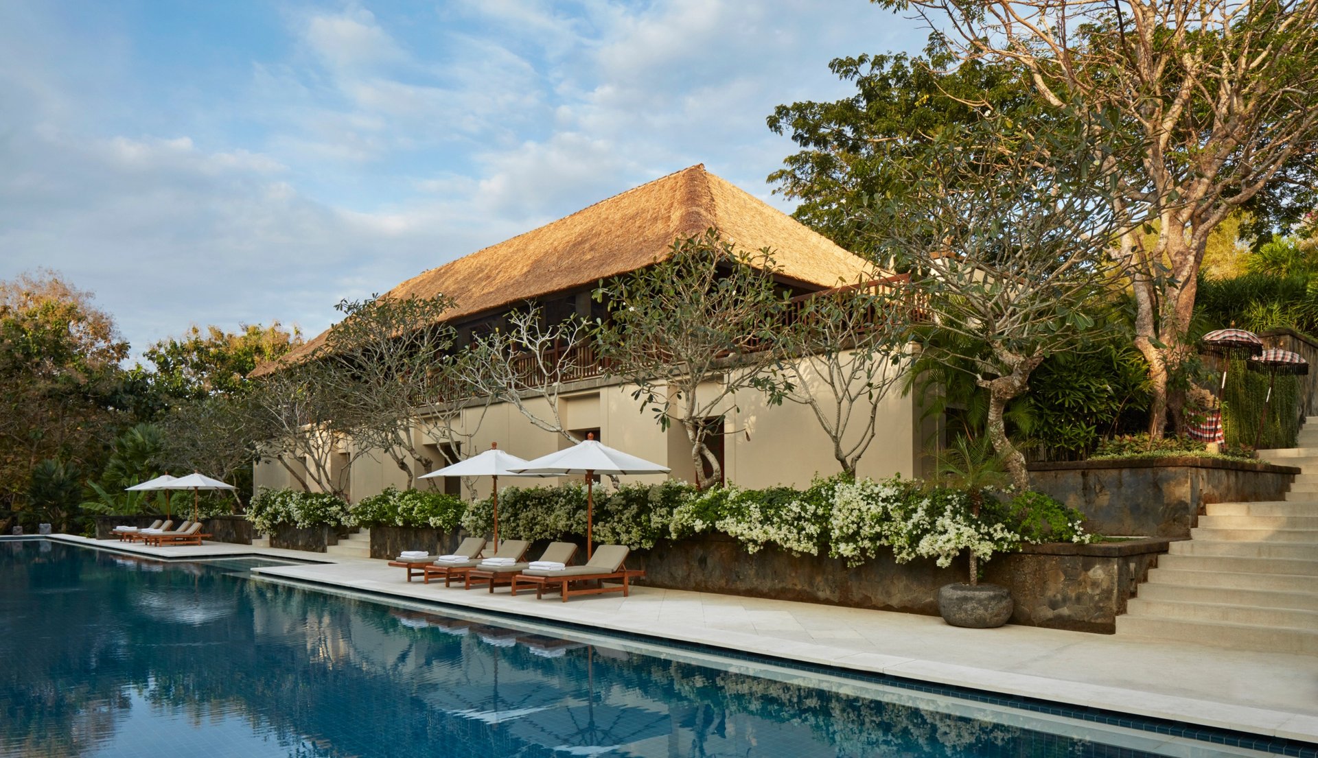 Luxury Aman Villa at Nusa Dua, Bali, featuring a private infinity pool, tropical garden, and modern Balinese architecture 
