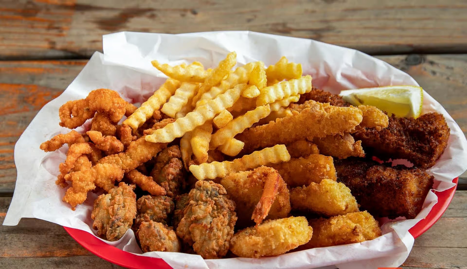 Captain’s Combo Platter Meal with fried fish, clams, oysters, shrimp, calamari, and crinkle‑cut fries from Captain’s Galley
