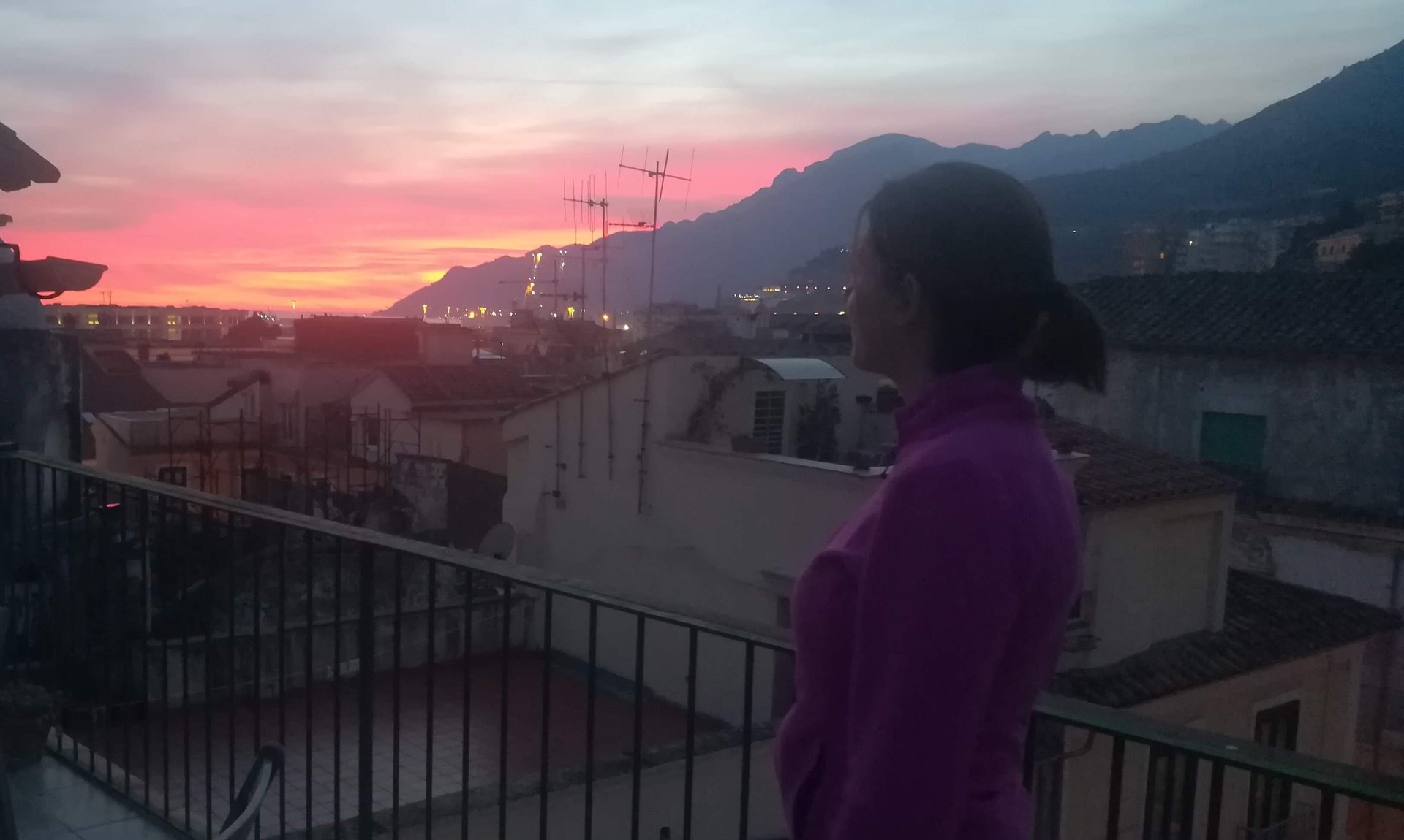 Giusy watching the sunset over the Amalfi Coast from the terrace in Salerno