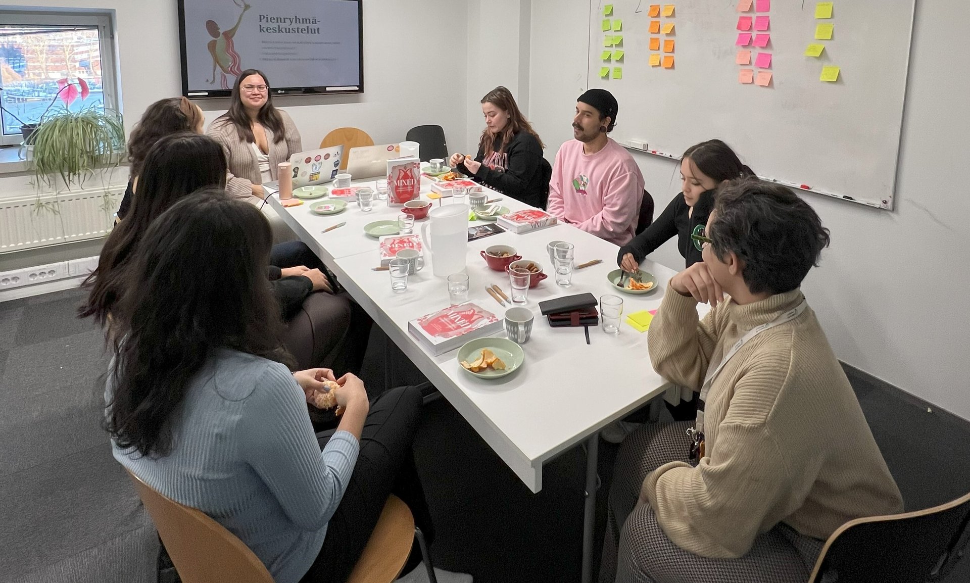 a group of people sitting around a table