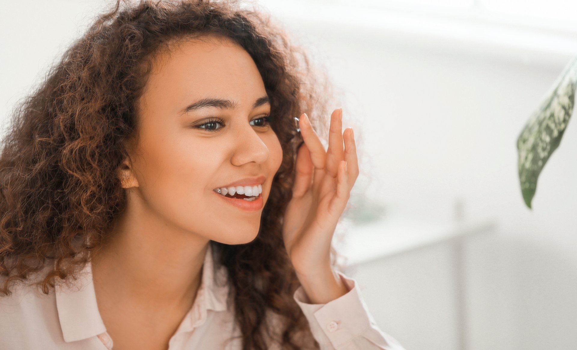 Woman smiling while putting in a contact lens
