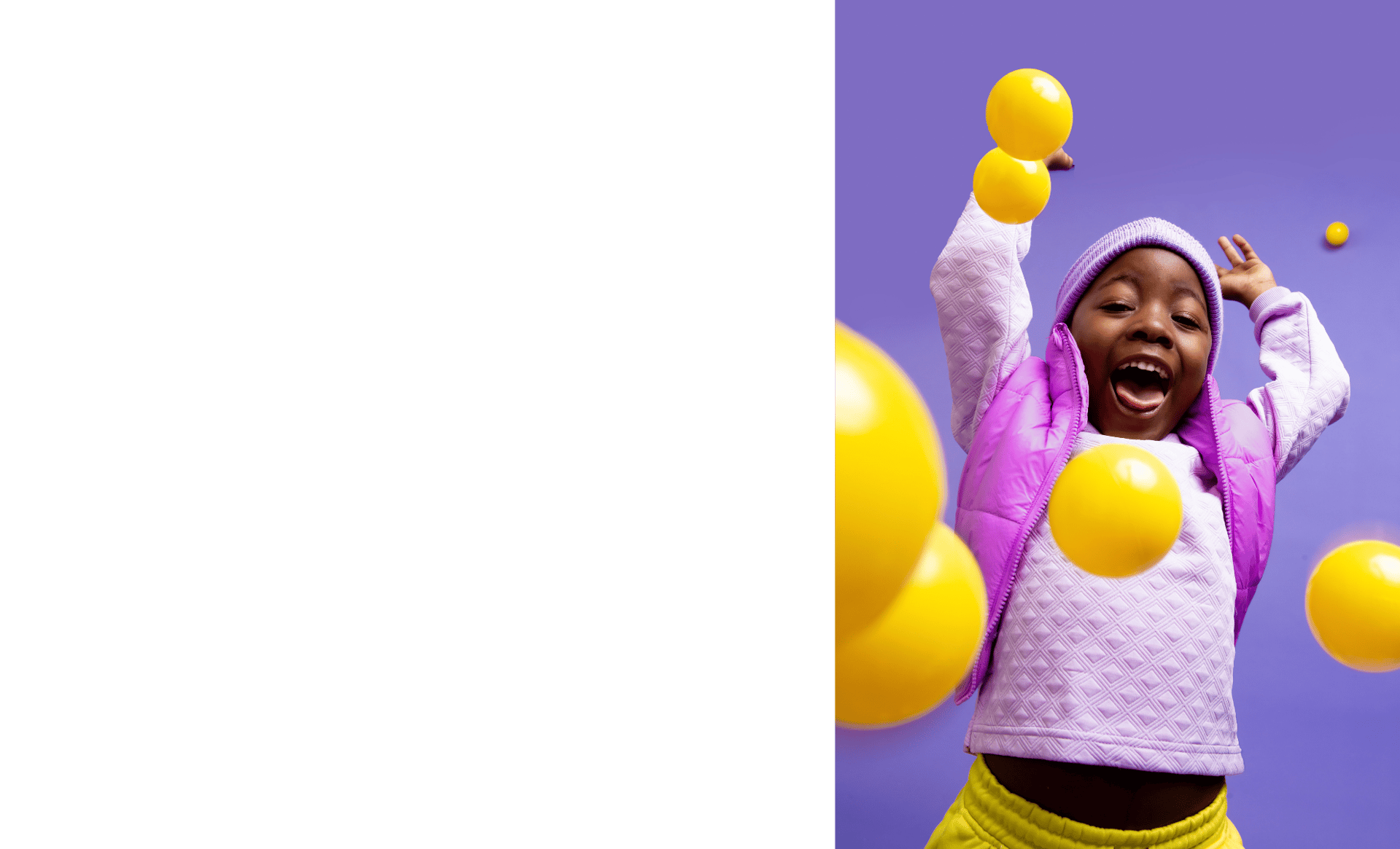 Child happily playing with balls