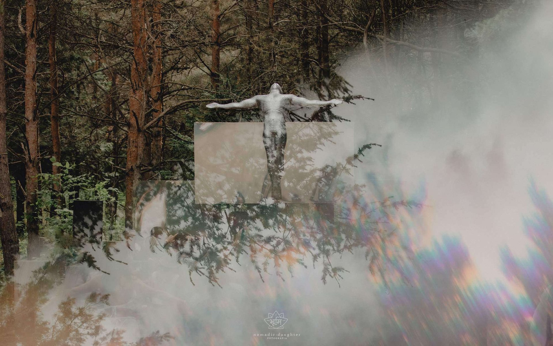 stage design of of a man standing with open arms in a misty forest landscape.