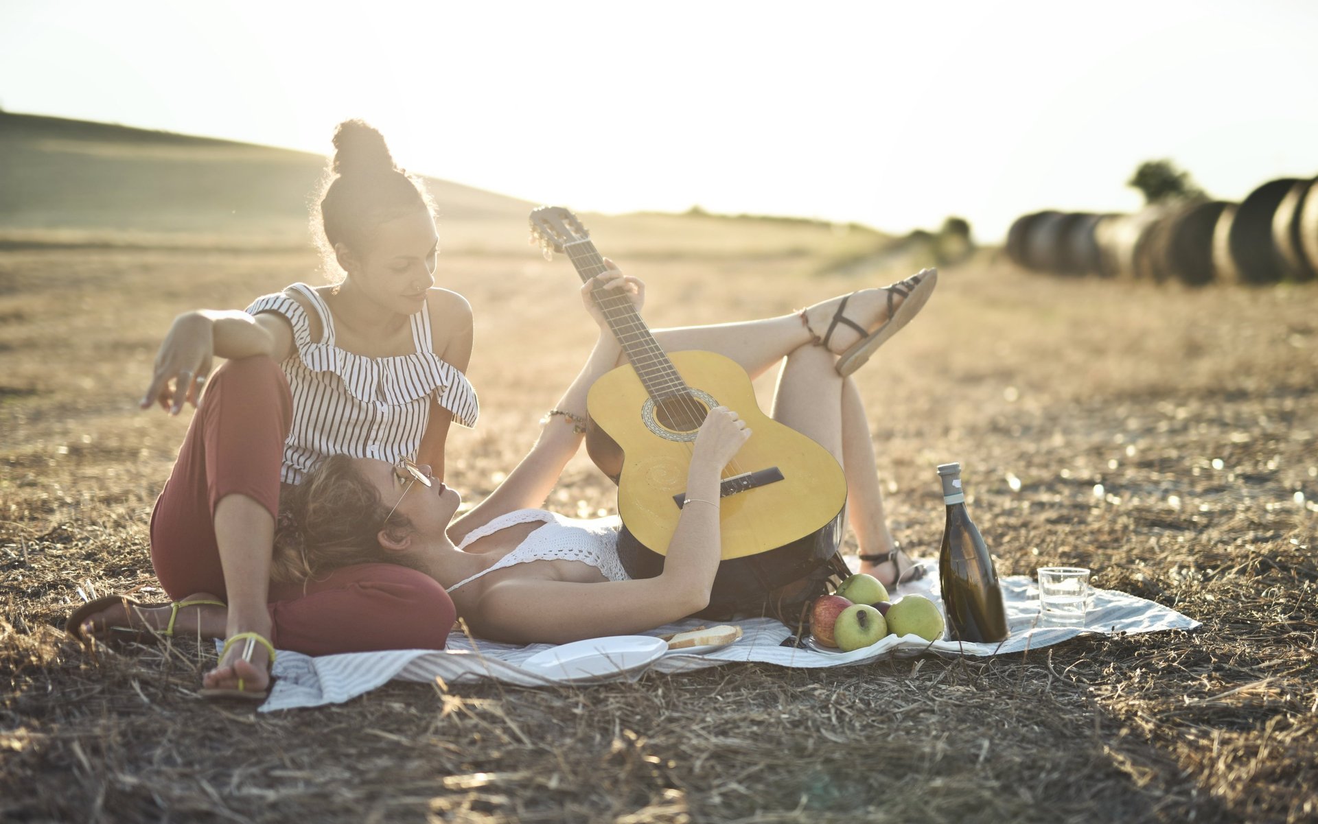 two women playing guitar