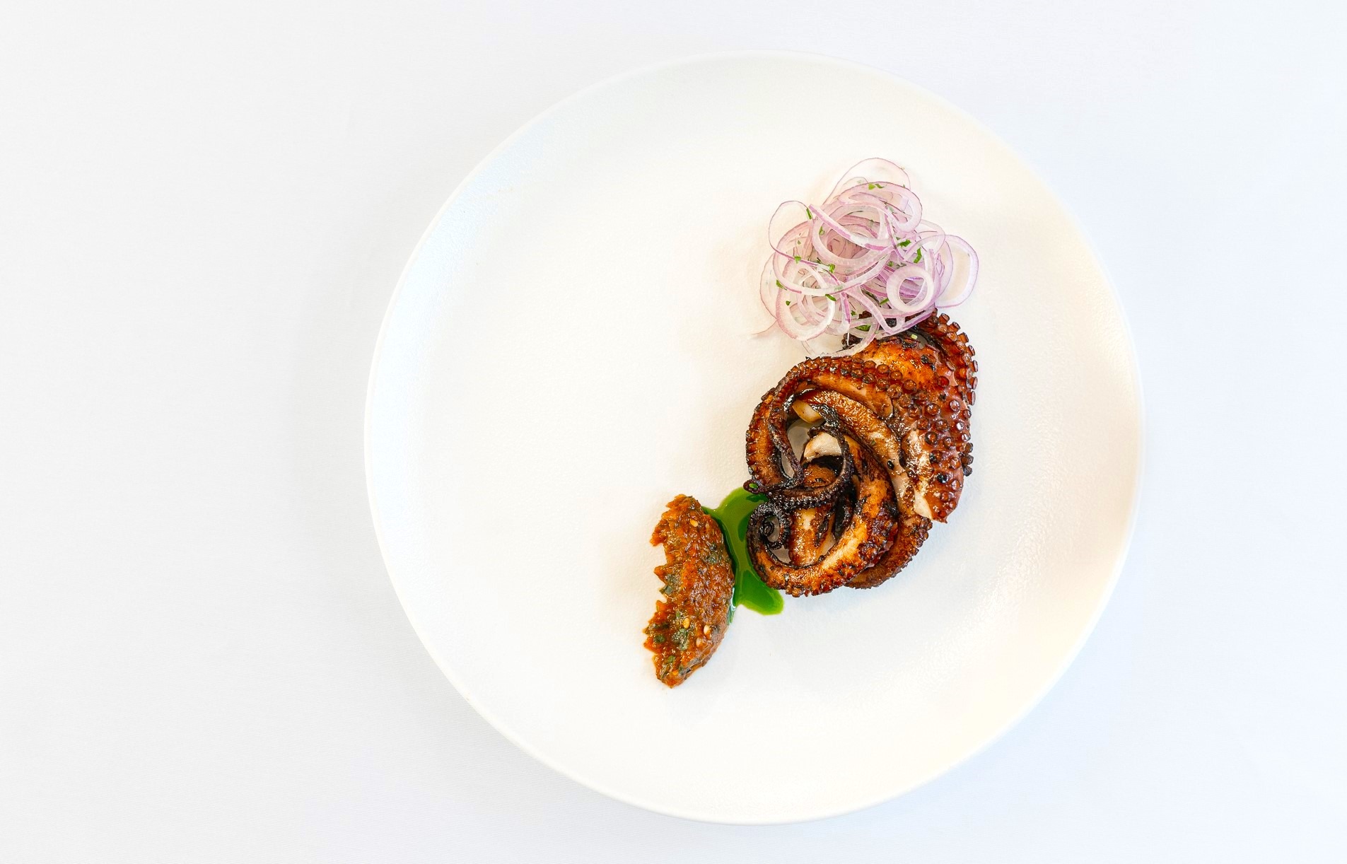 Grilled octopus with tomato-herbs sauce & basil oil, dish prepared by Villa Eats private chefs Naxos