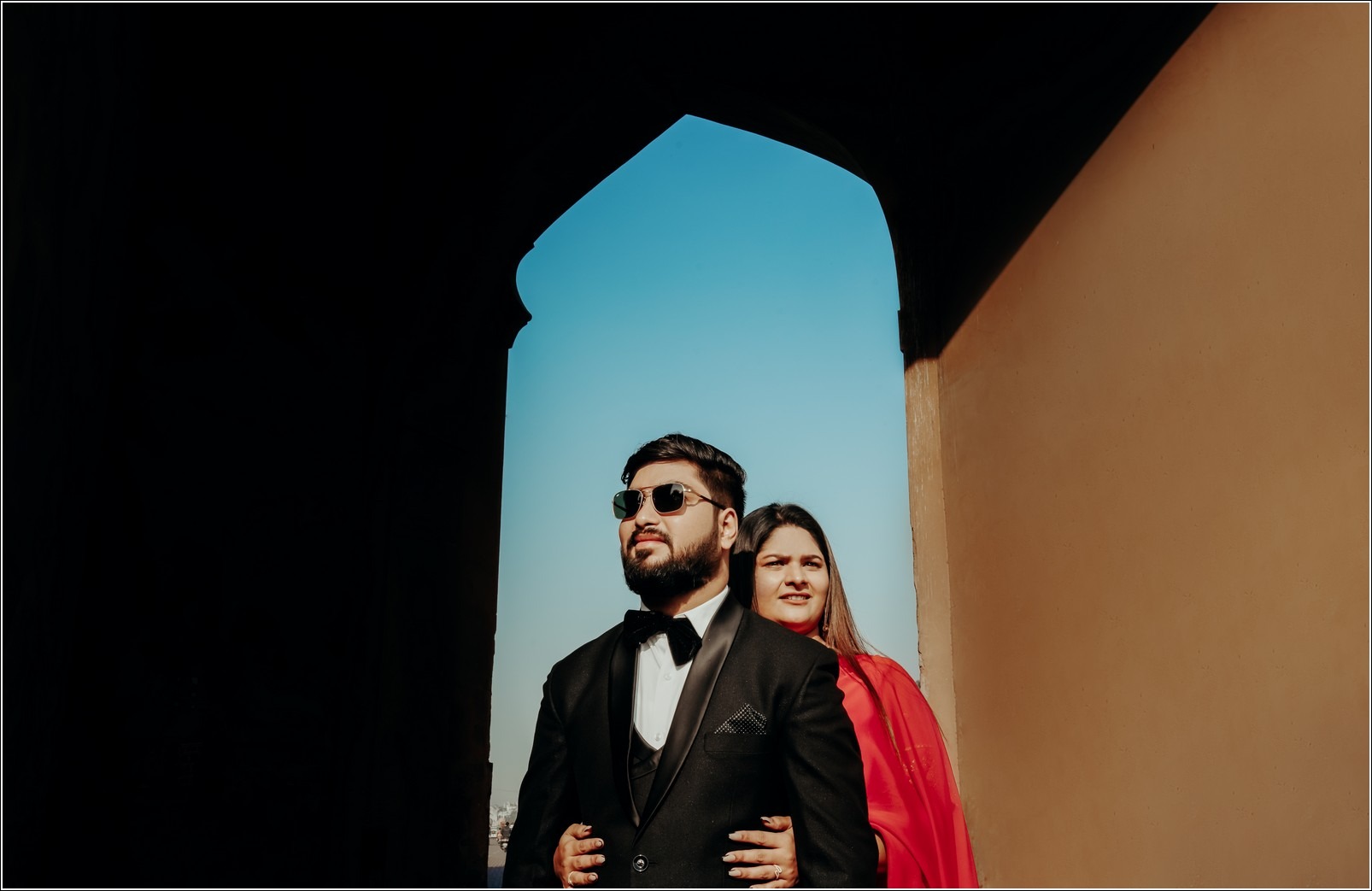 Couple posing in a rustic setting for their pre wedding photo