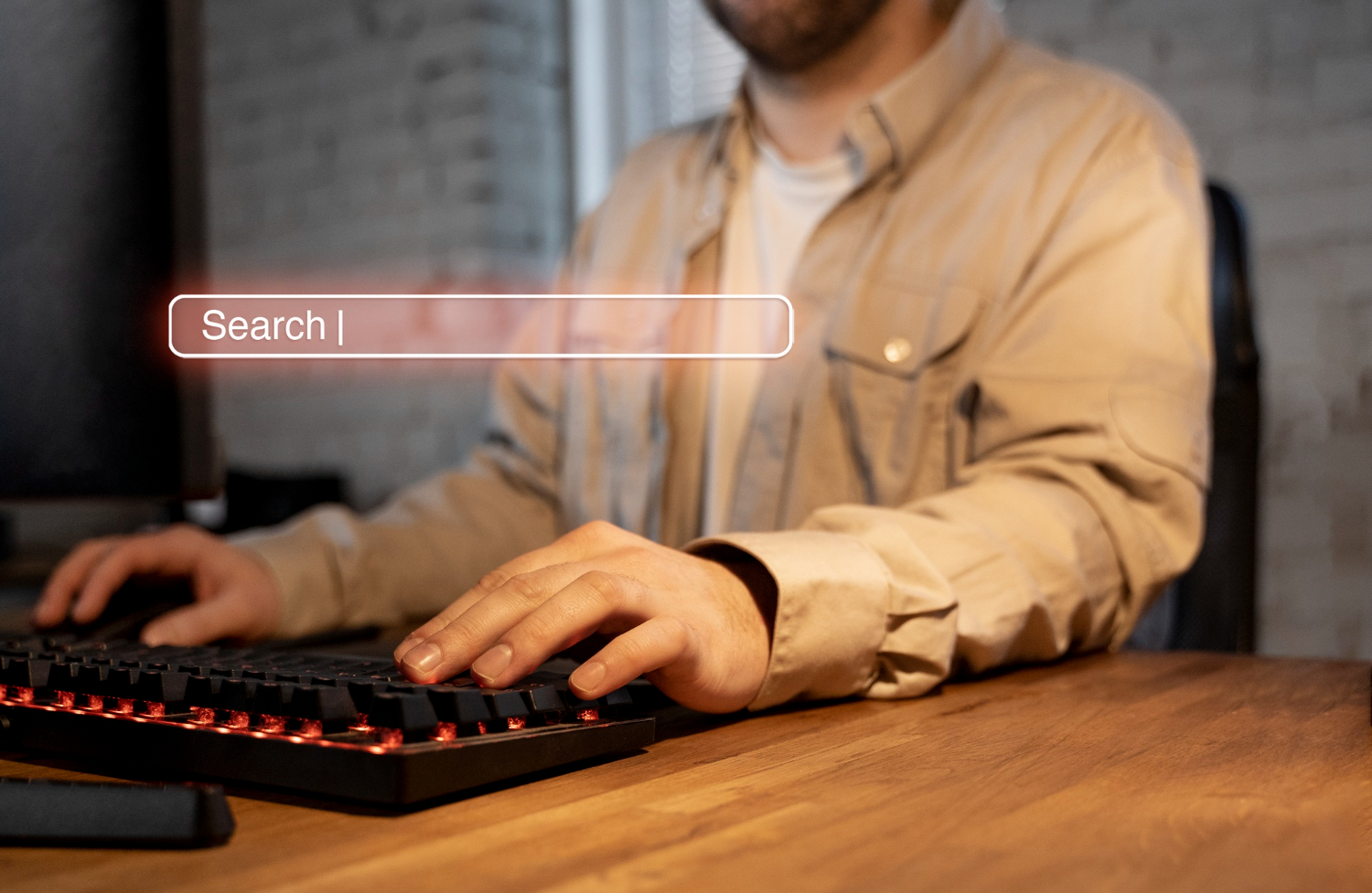 a man sitting at a desk with a keyboard and a keyboard