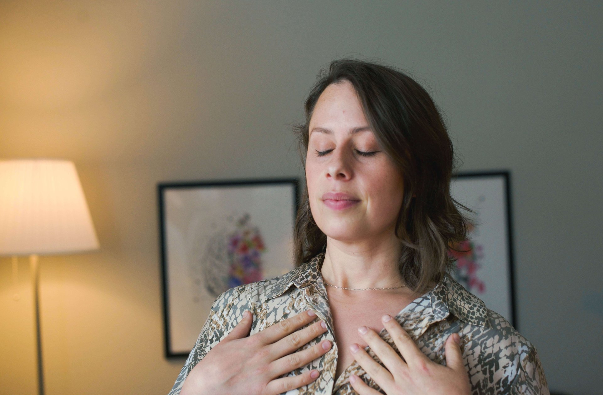 woman with short hair and eyes closed showing embodiment practices 