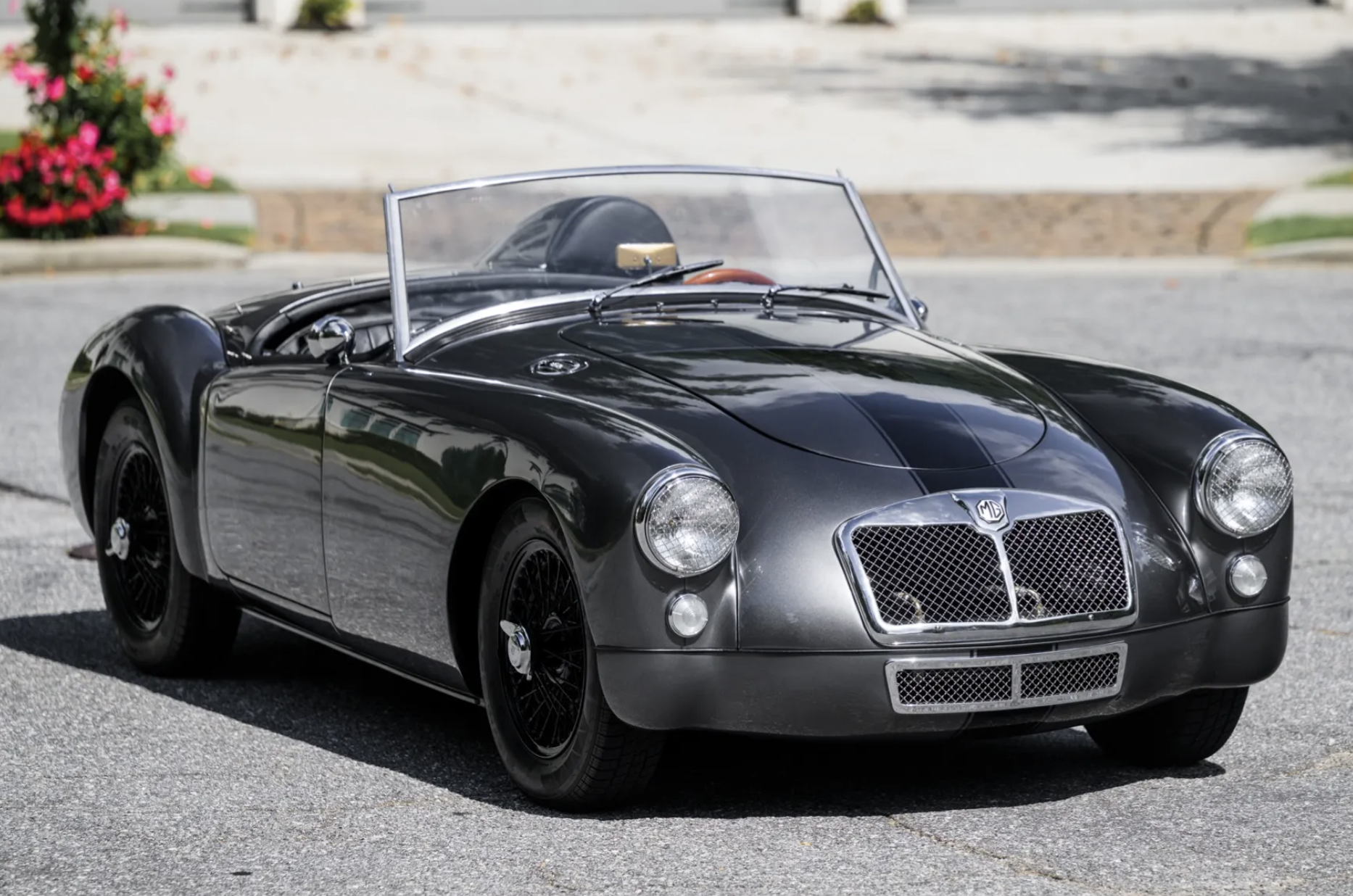3/4 profile view of a silver 1958 MG MGA Roadster.