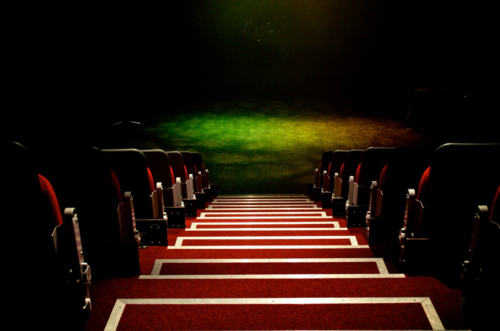 a red carpeted staircase casement with a red carpet