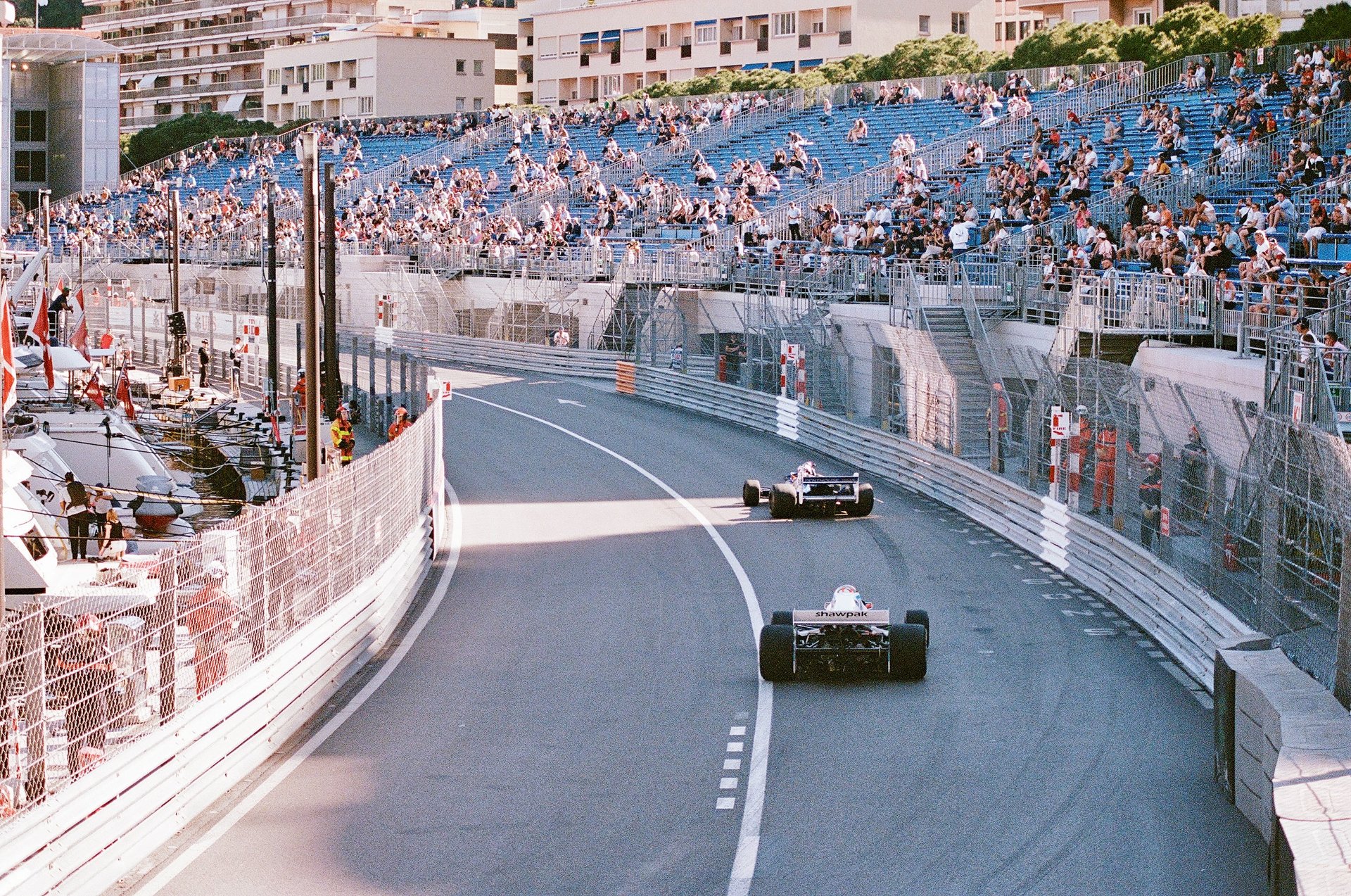a race car racing down a track with spectators watching
