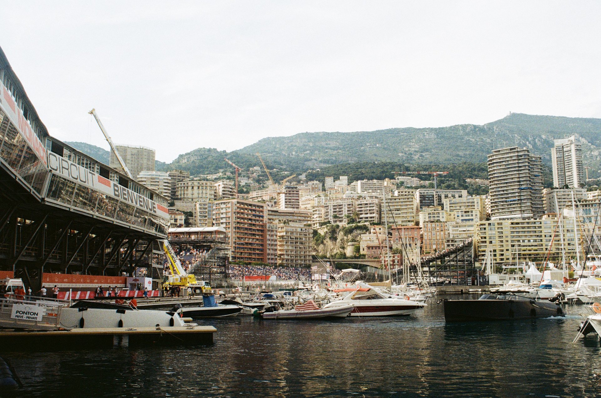 a harborfront of a city with a bridge over the water