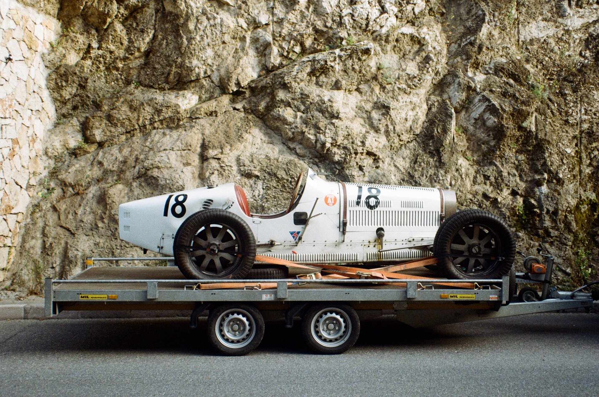 a Bugatti Type-35 on a trailer in the paddock