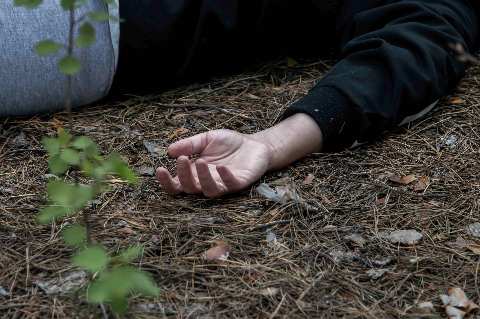 Image of woman lying on ground, doubtless because she's fainted from of a lack of food.