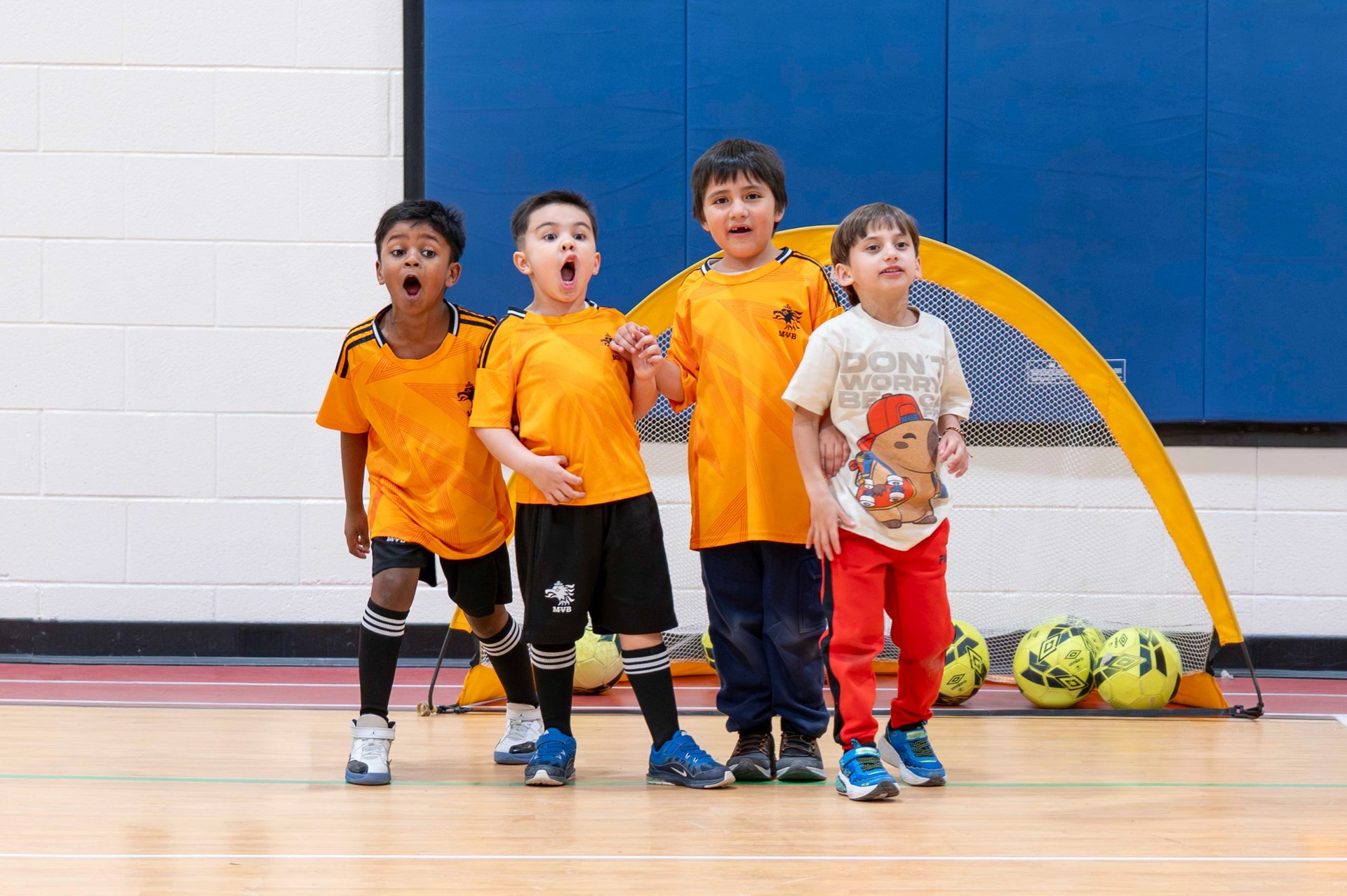 Children building confidence and coordination through beginner soccer training for kids