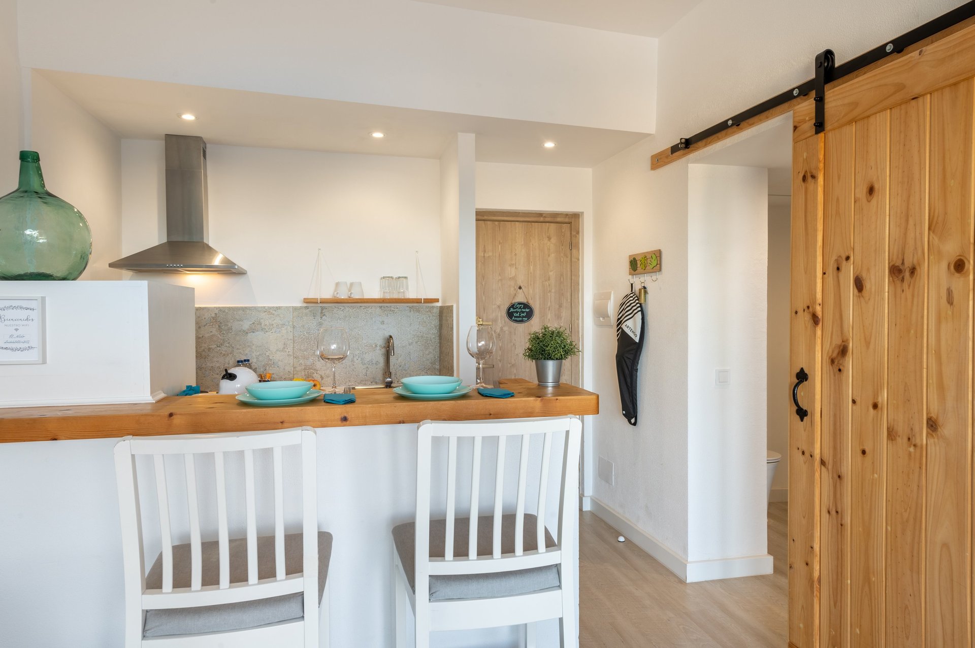 kitchen with American-style bar table and high wooden chairs