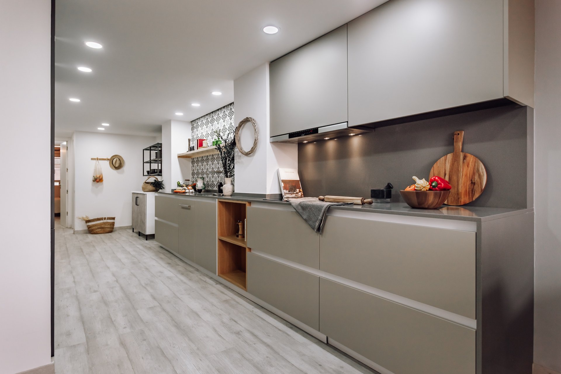 Open-plan kitchen with patterned tiles, neutral tones in Rute apartment interior design