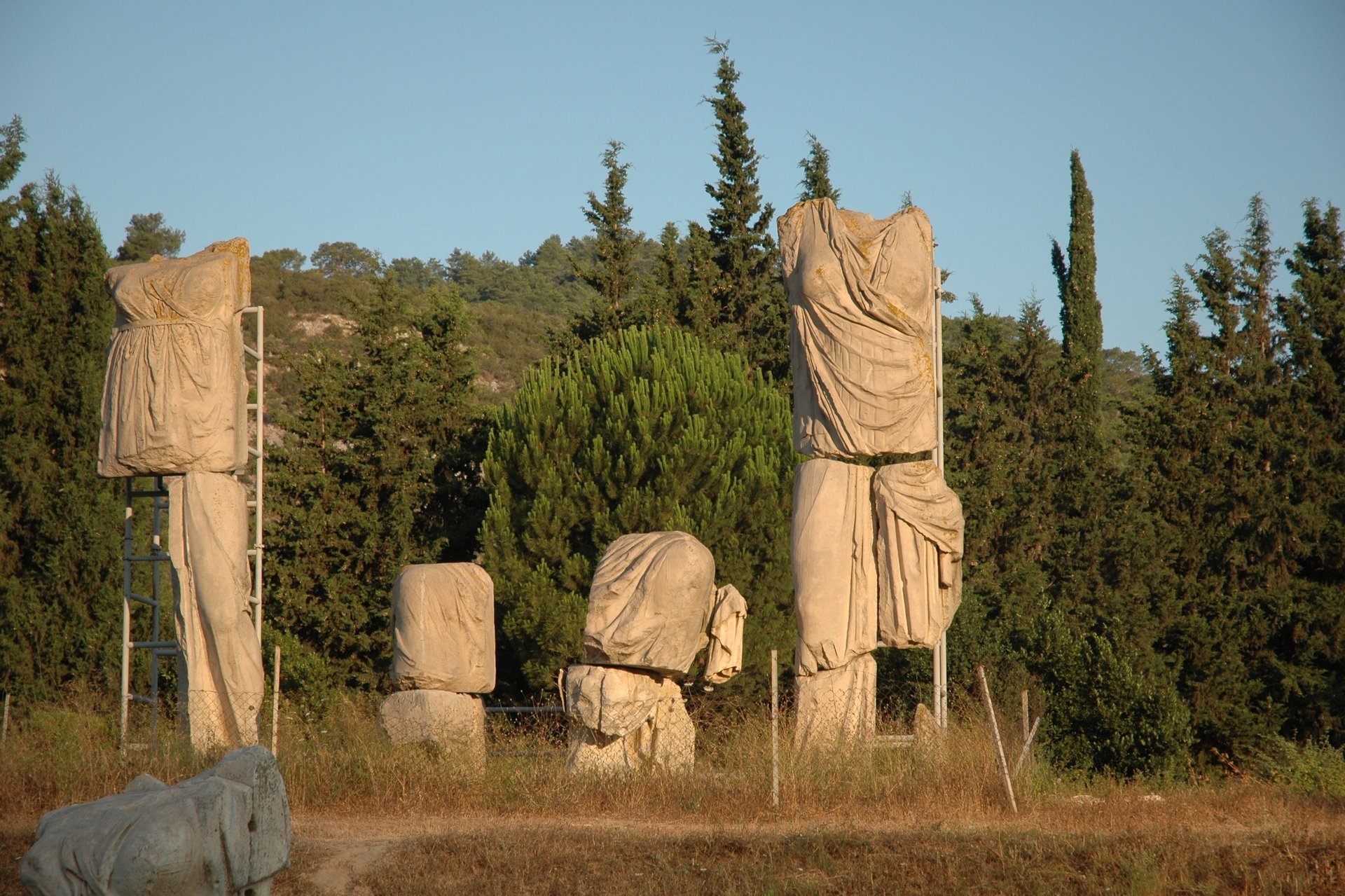 Ancient Greek limestone draped statues at an archaeological site in Claros, Turkey.