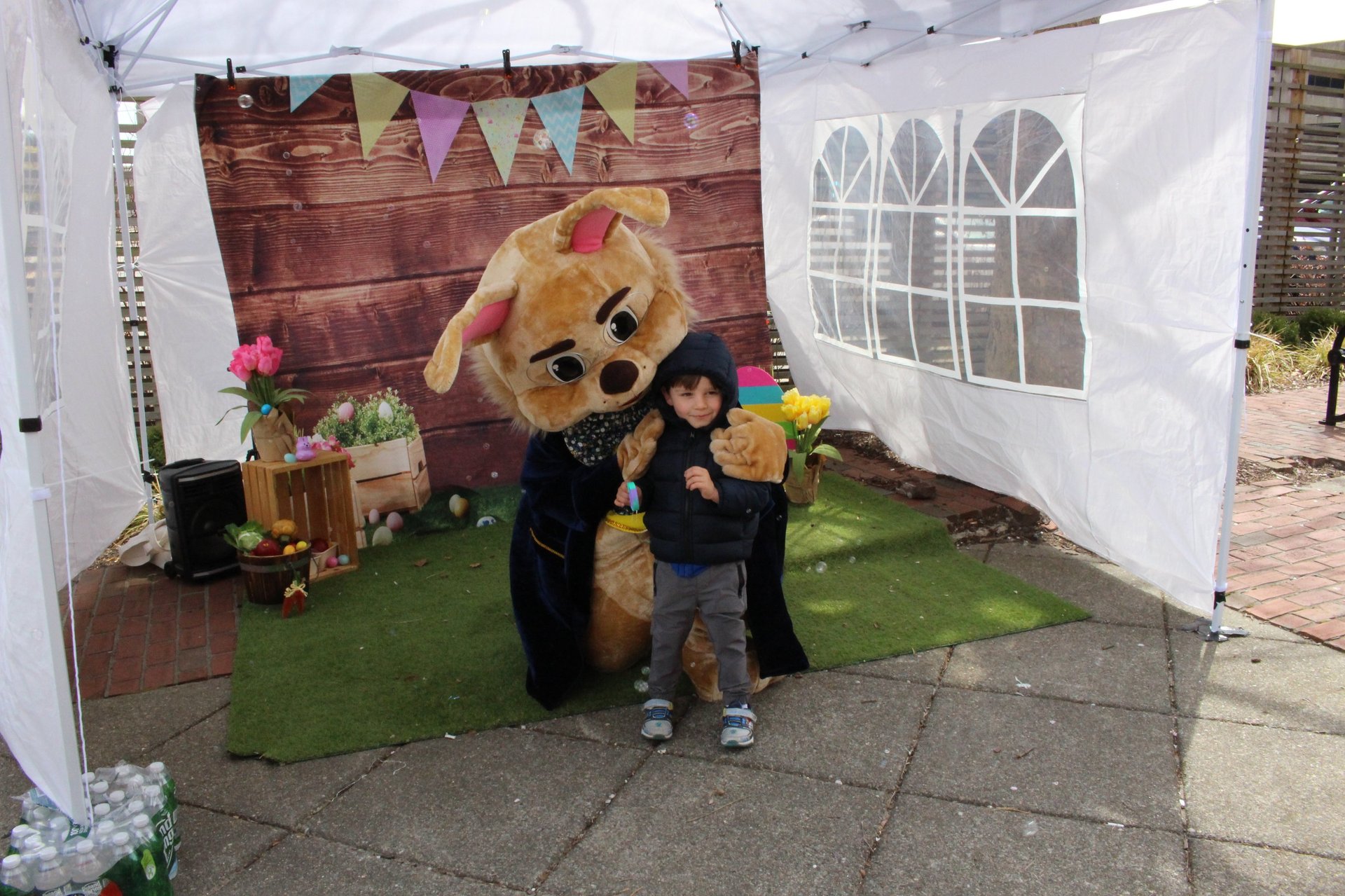 Easter Bunny shares a hug with a kid