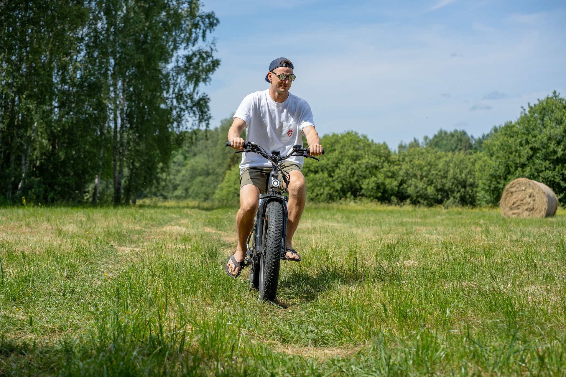 a man riding an electric bicycle in a field