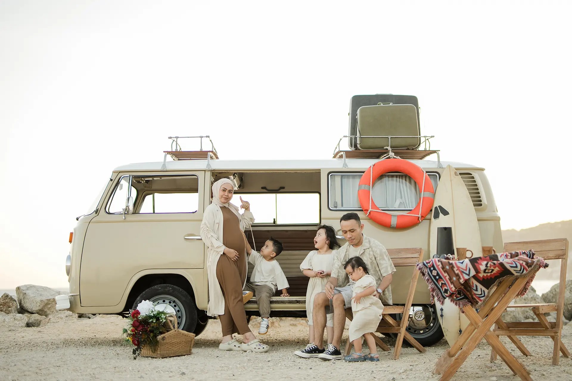 Relaxed picnic style family photography session with vintage combi van at Melasti Beach Bali