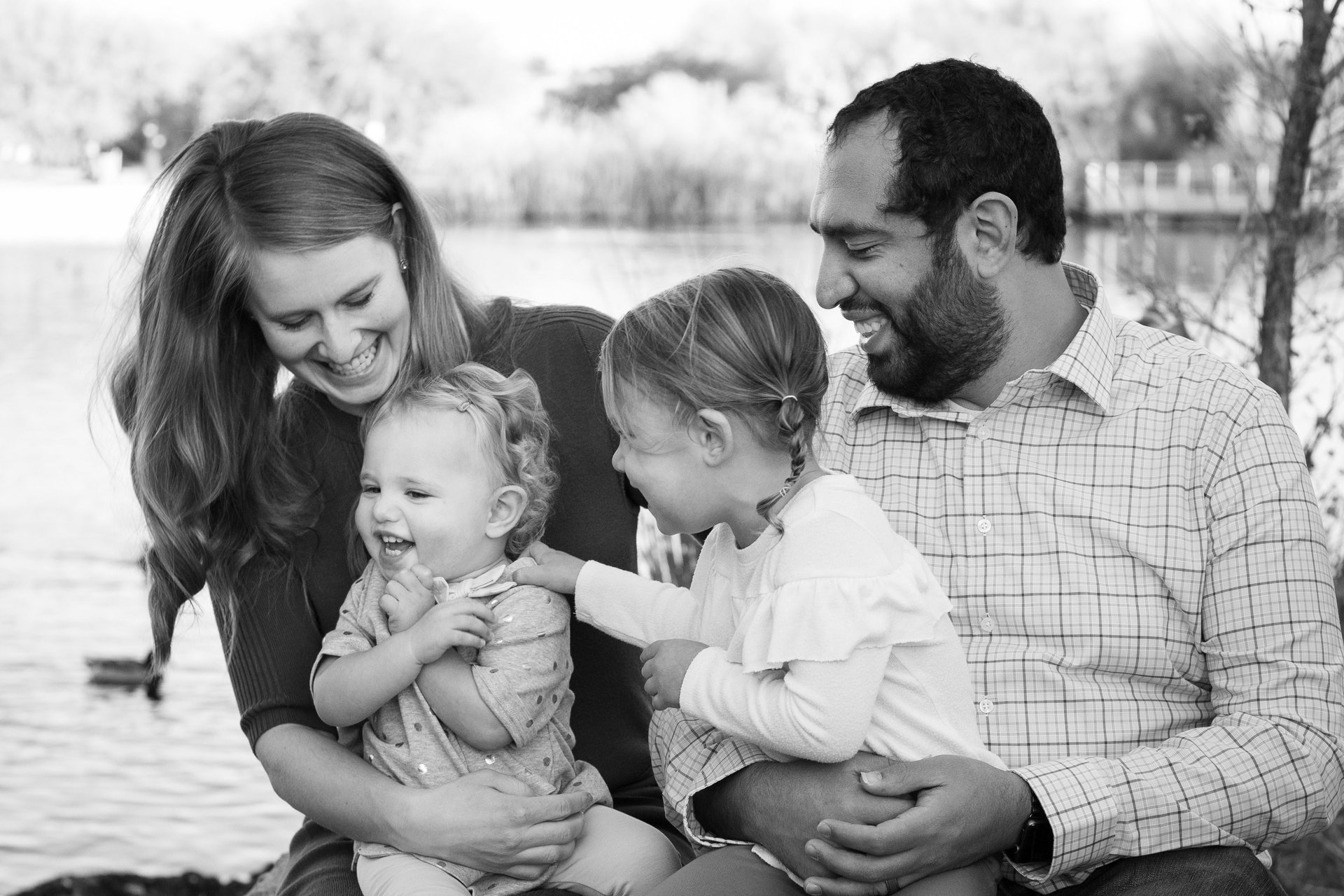 Parents laughing with their young children during an outdoor family photography session in Arizona.