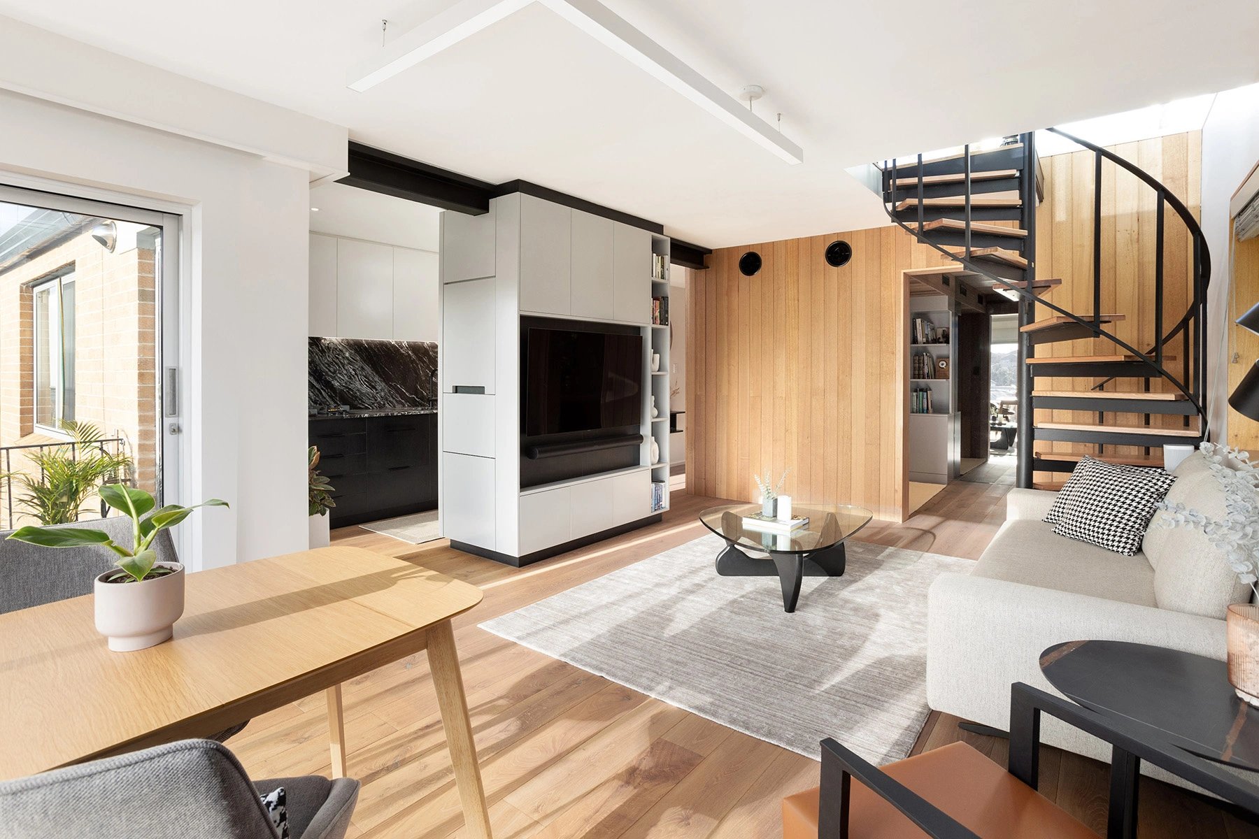 contemporary design of the renovated living room in Mosman Bay with central TV joinery cabinet and timber features