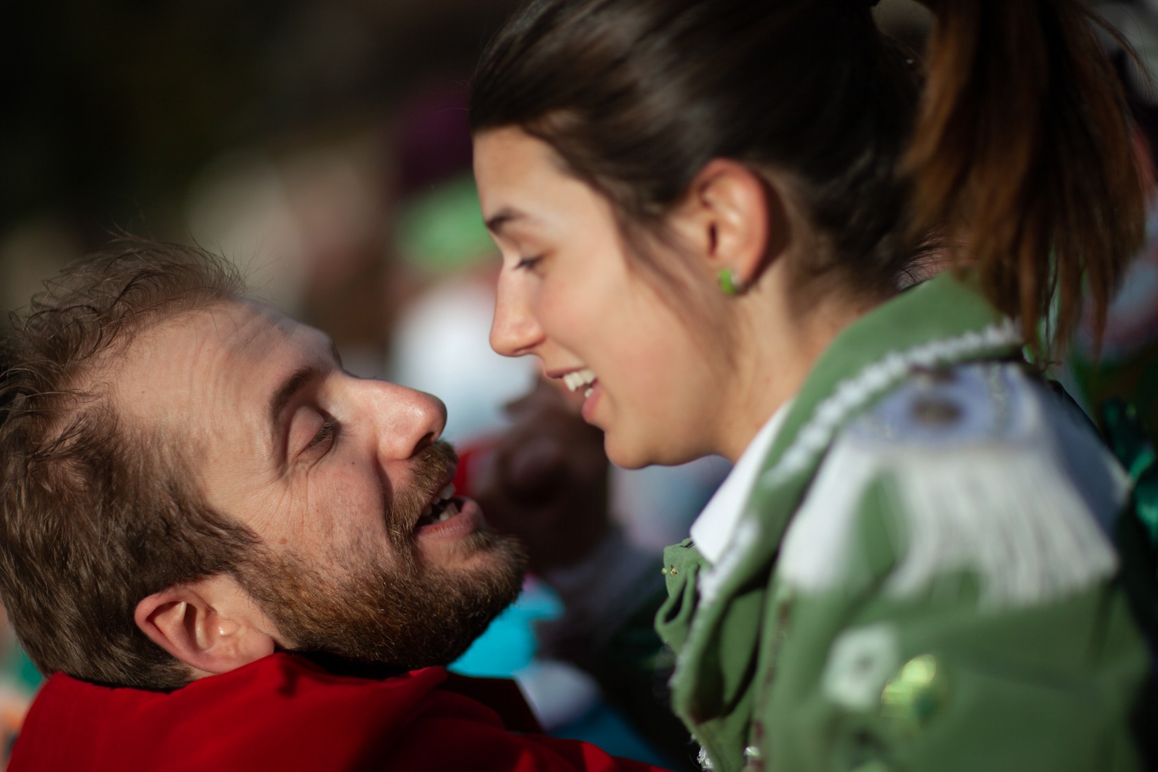 a man and woman are smiling and looking at each other