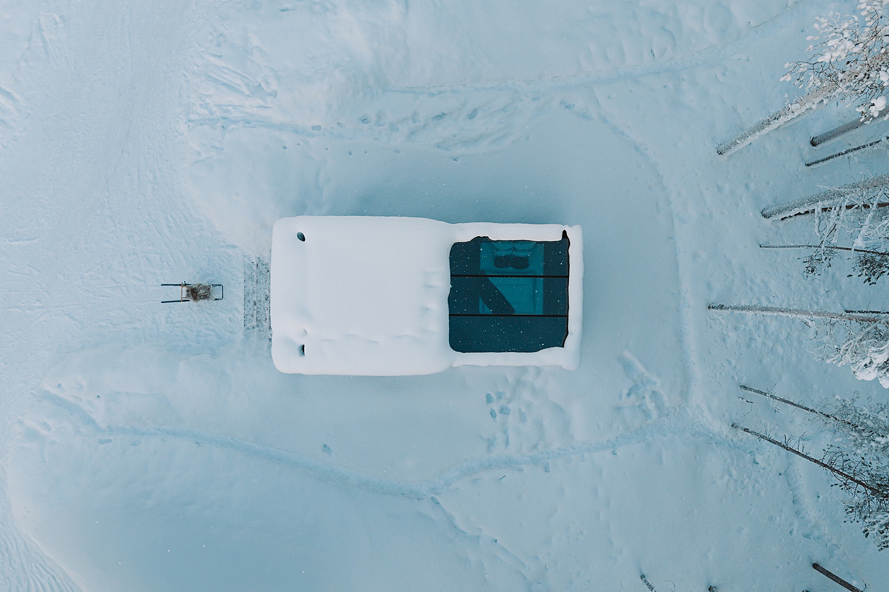 Aerial view of Lapland resort in snowy environment with surrounding nature