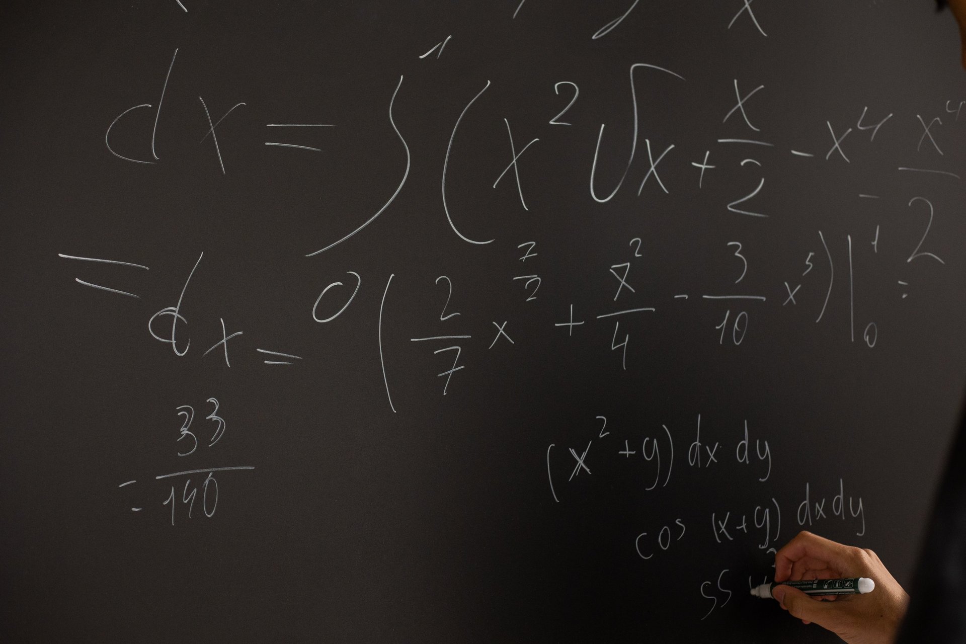 A chalkboard with fractions on it representing how to track customer health scores.