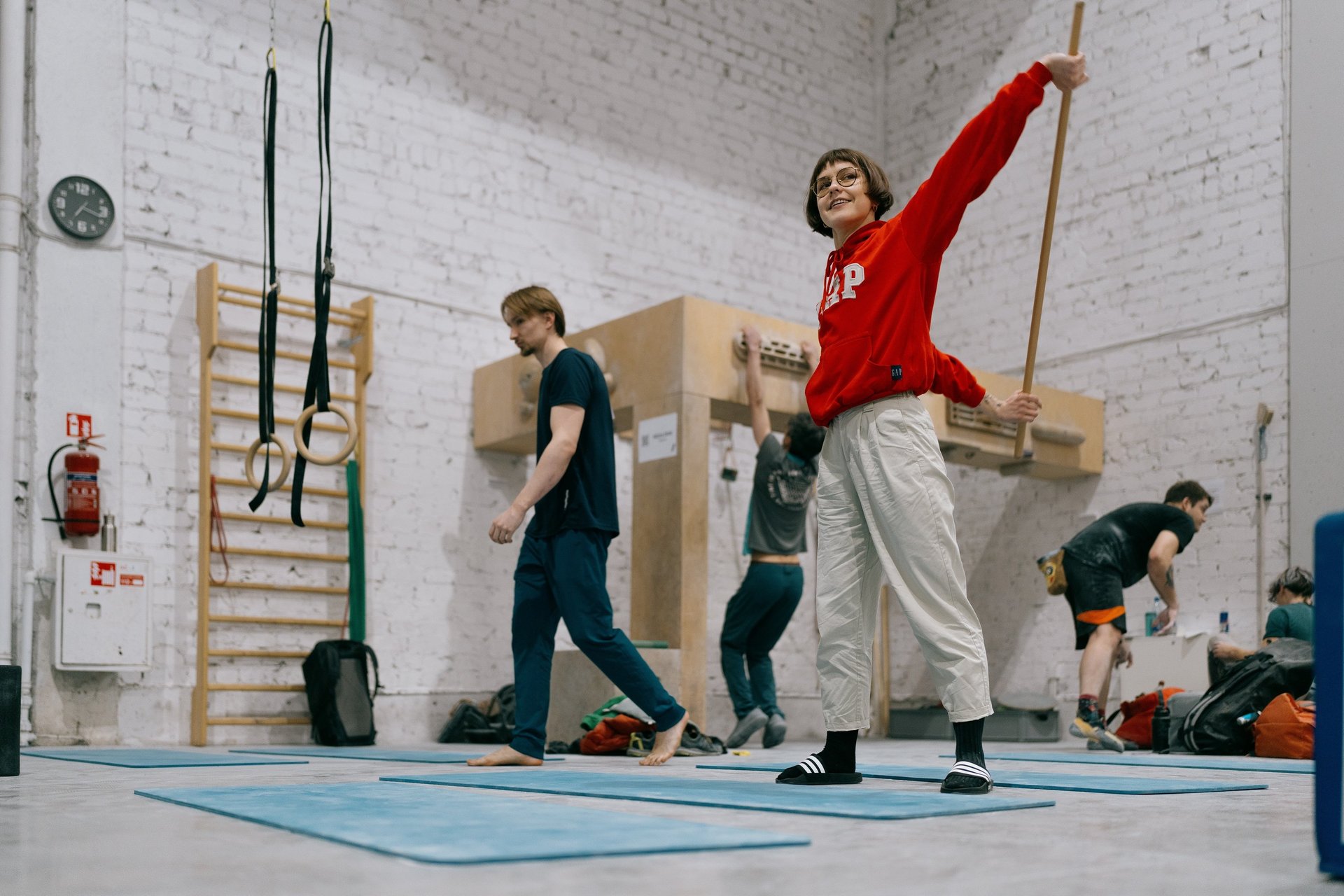 a woman in a red sweater is stretching