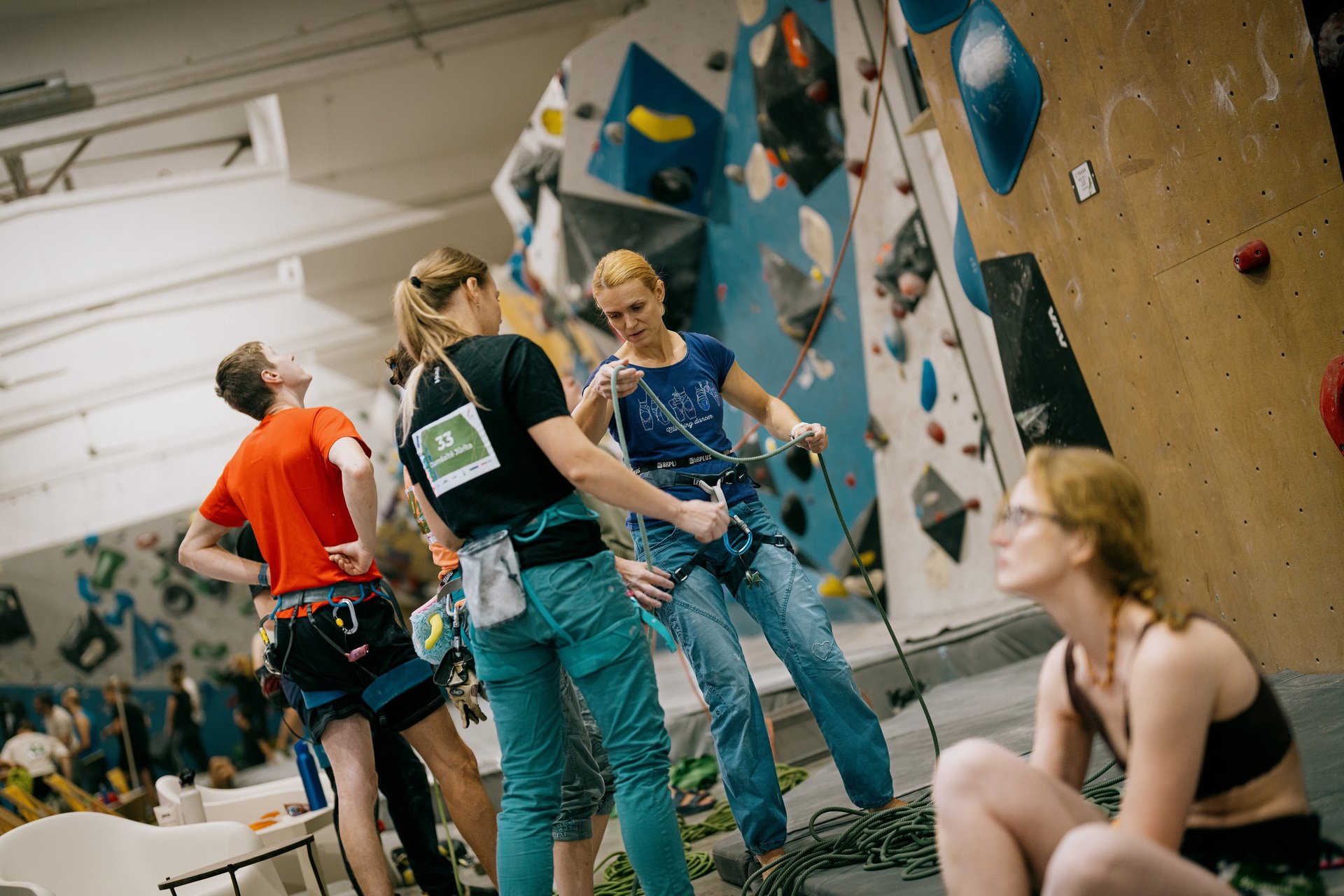 climbers in a climbing wall are checking the rope