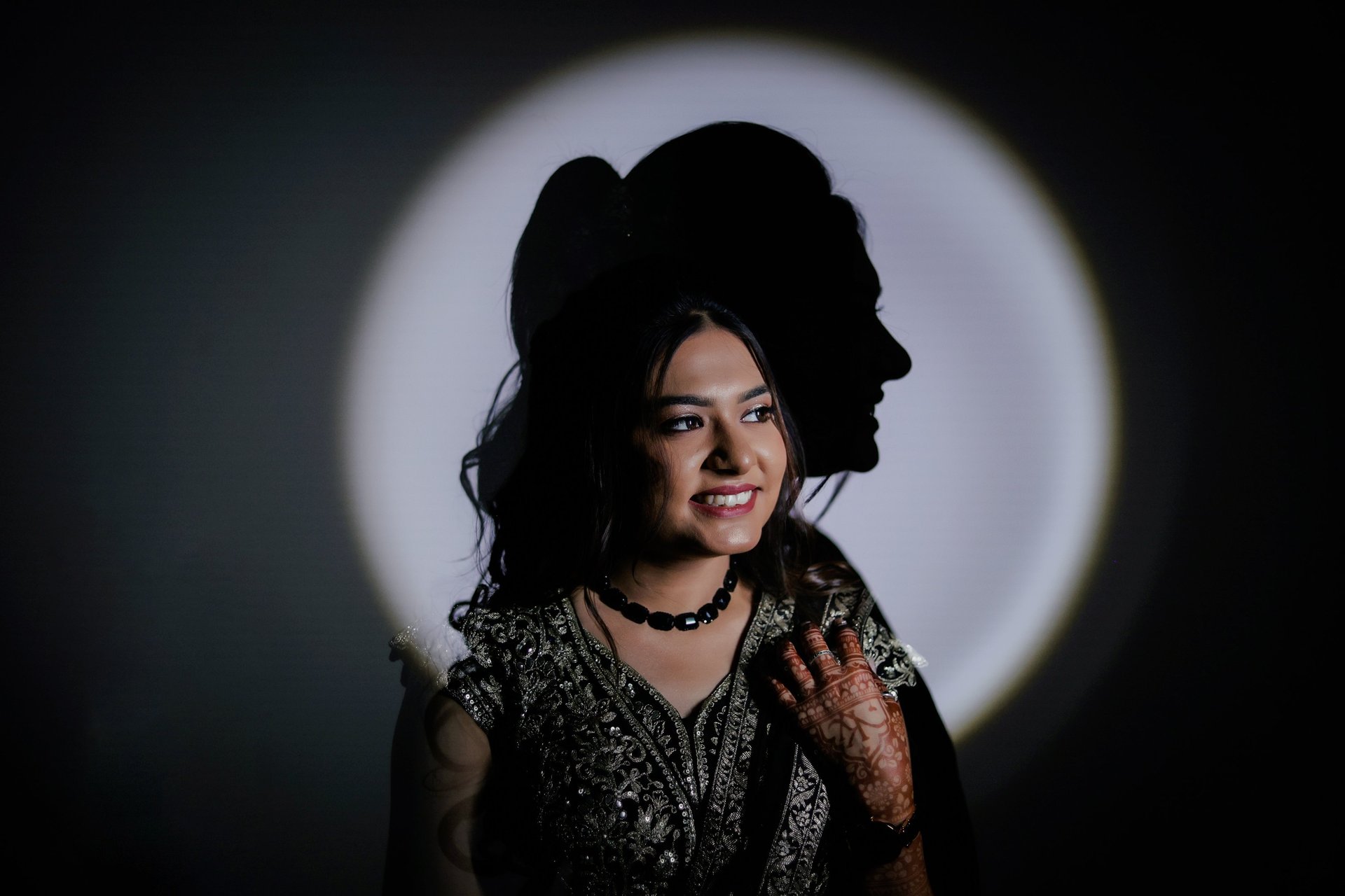 Creative bridal portrait with shadow light effect showing Indian bride with natural glowing bridal m