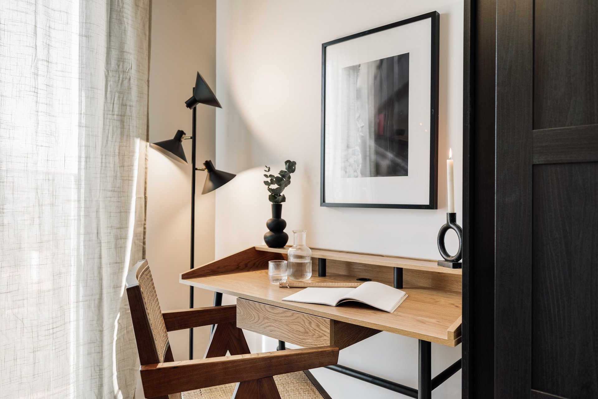 Working area with wood desk and subtle lighting, cozy decor and natural colour palette