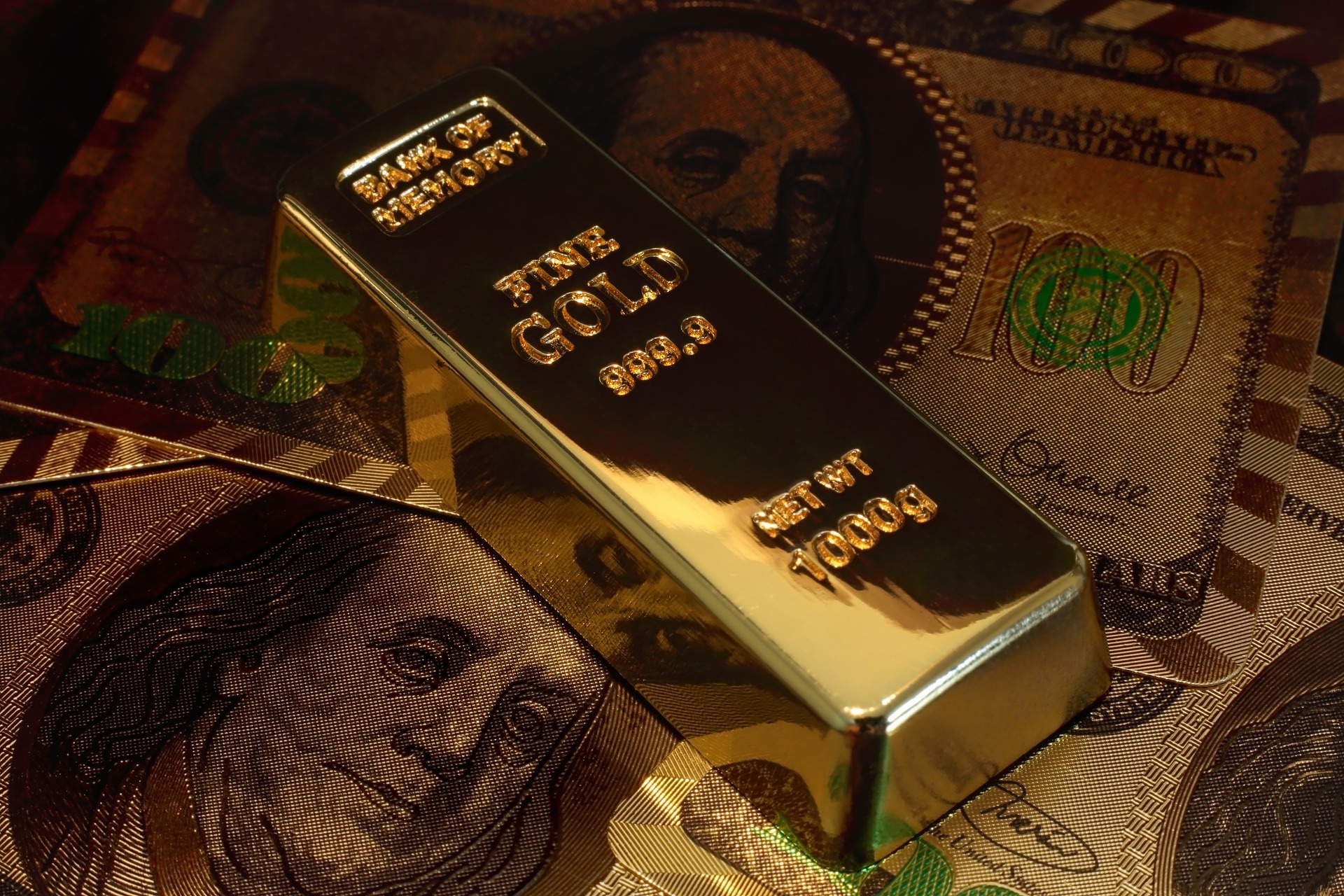 gold bar on top of US money