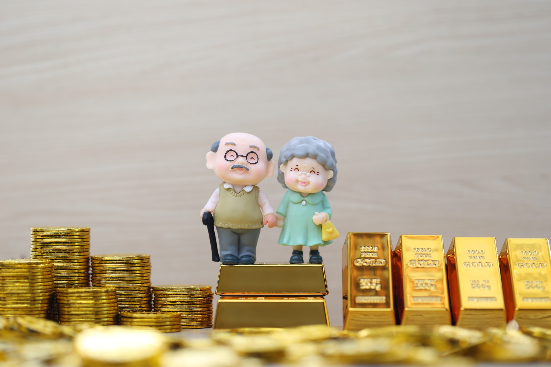 elderly couple with gold bars and coins for retirement