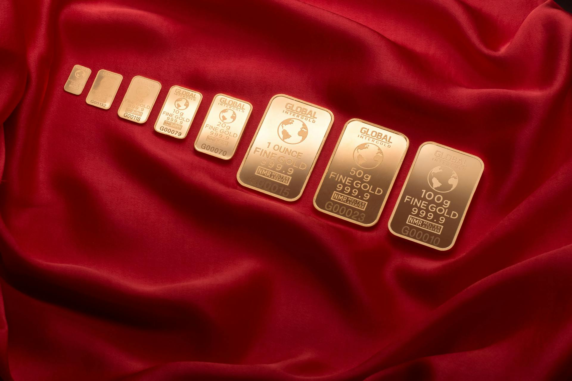 gold bars layed out in a row symbolizing blog post augusta precious metals, a gold ira company and why you should choose them