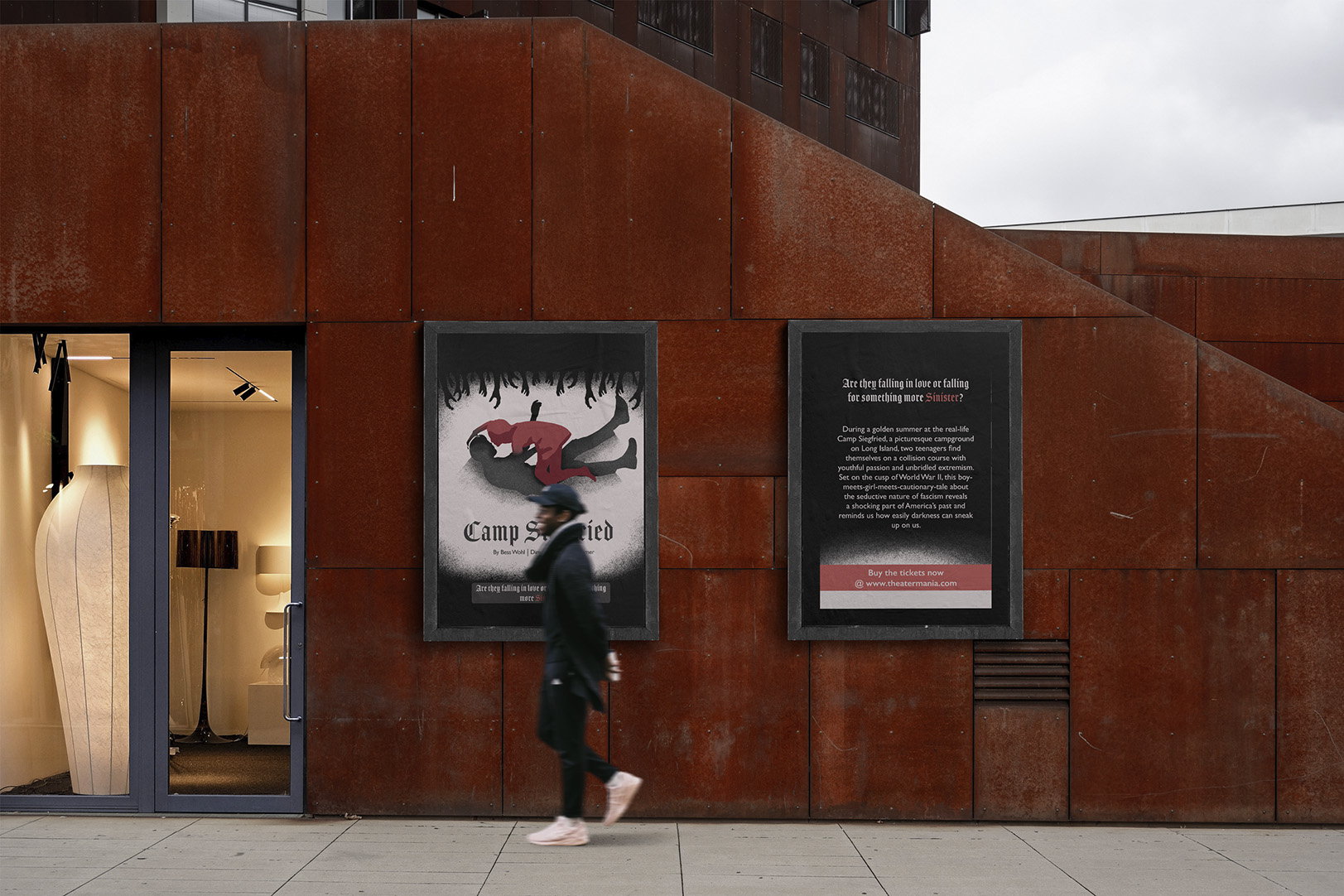 A person walking past theater posters for Camp Siegfried on a modern rust-colored building wall.