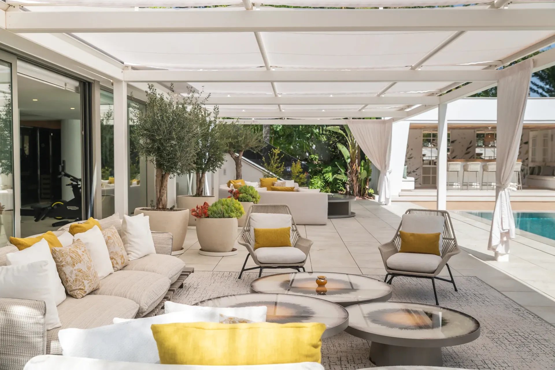 Shaded poolside sofas and lounge area at Villa Serenity Marbella