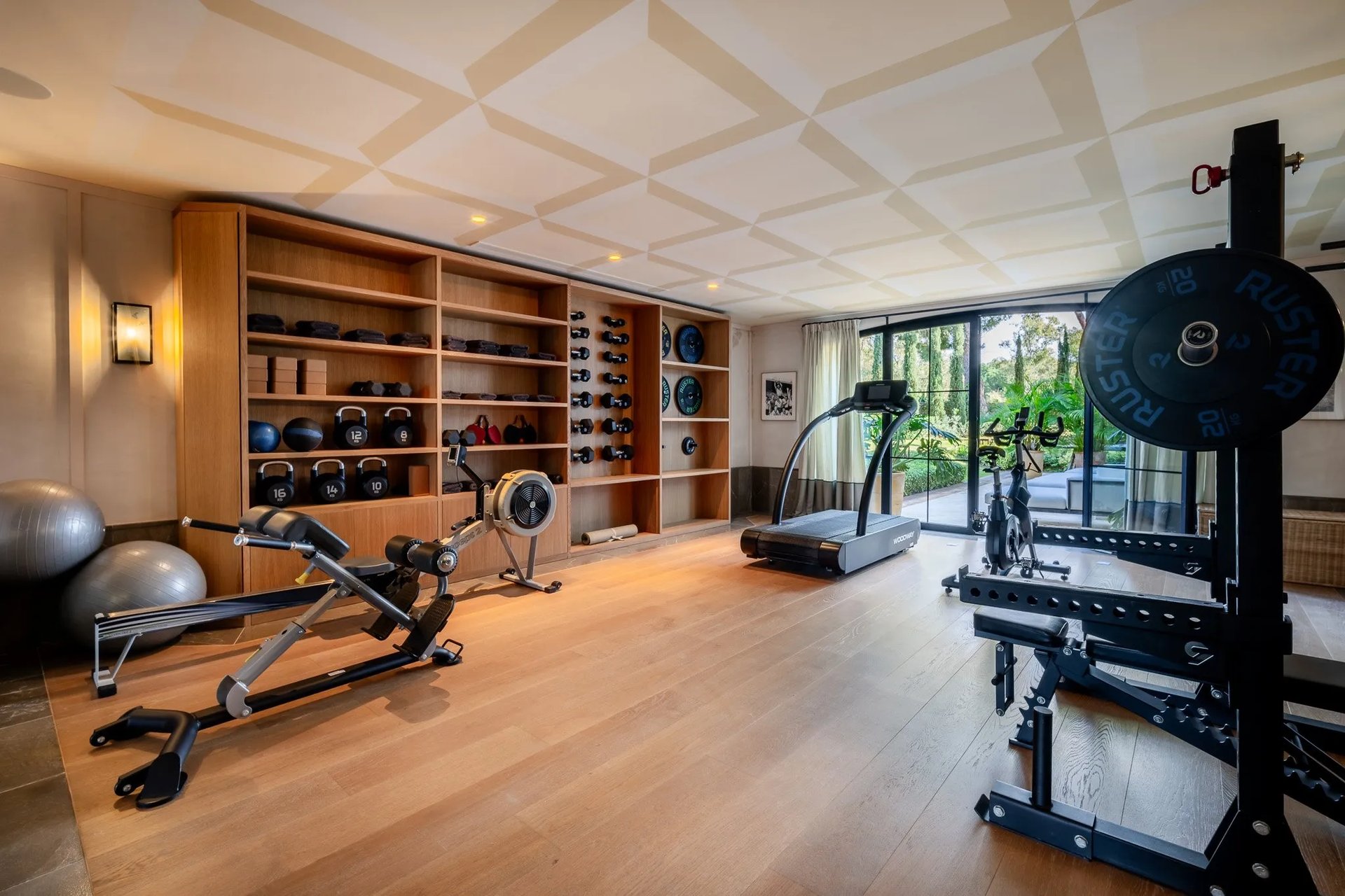 Private gym at Villa La Gratitud with modern equipment and garden views