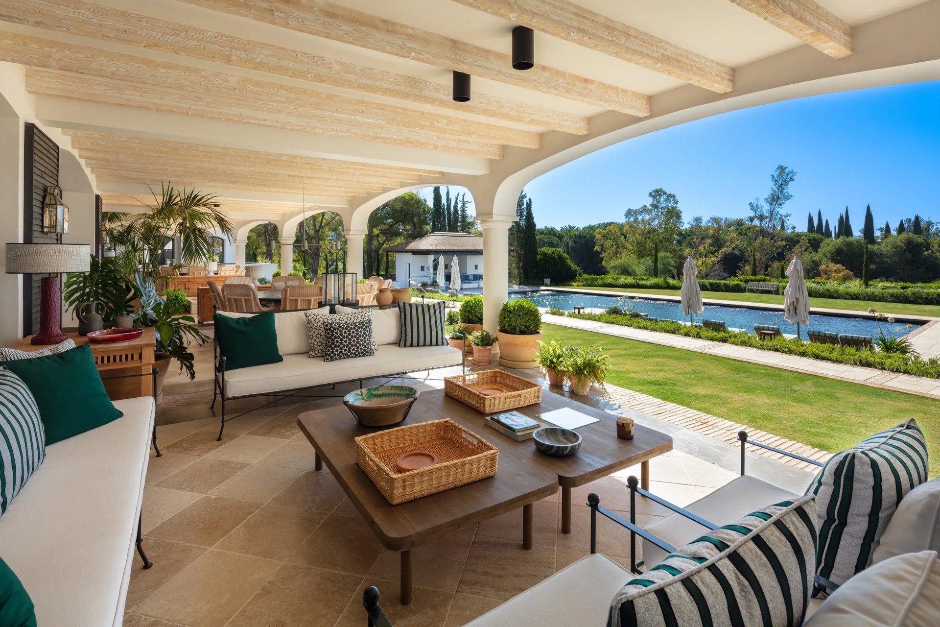 Shaded terrace lounge overlooking the pool