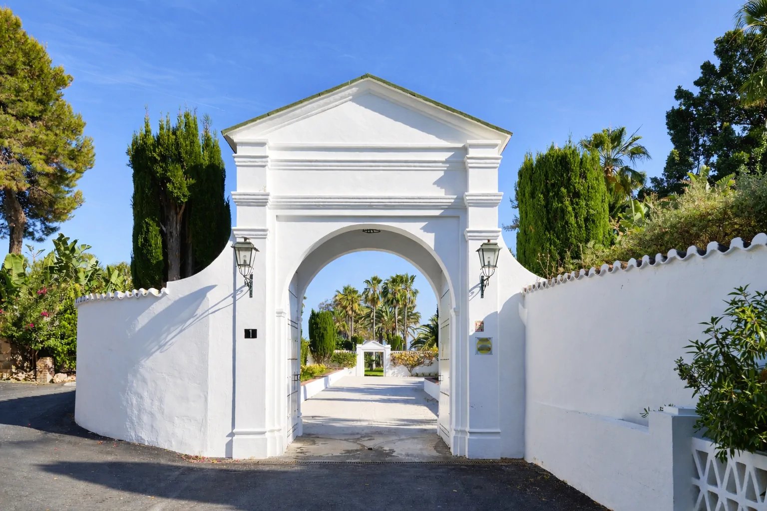 White entrance archway to beachfront hacienda