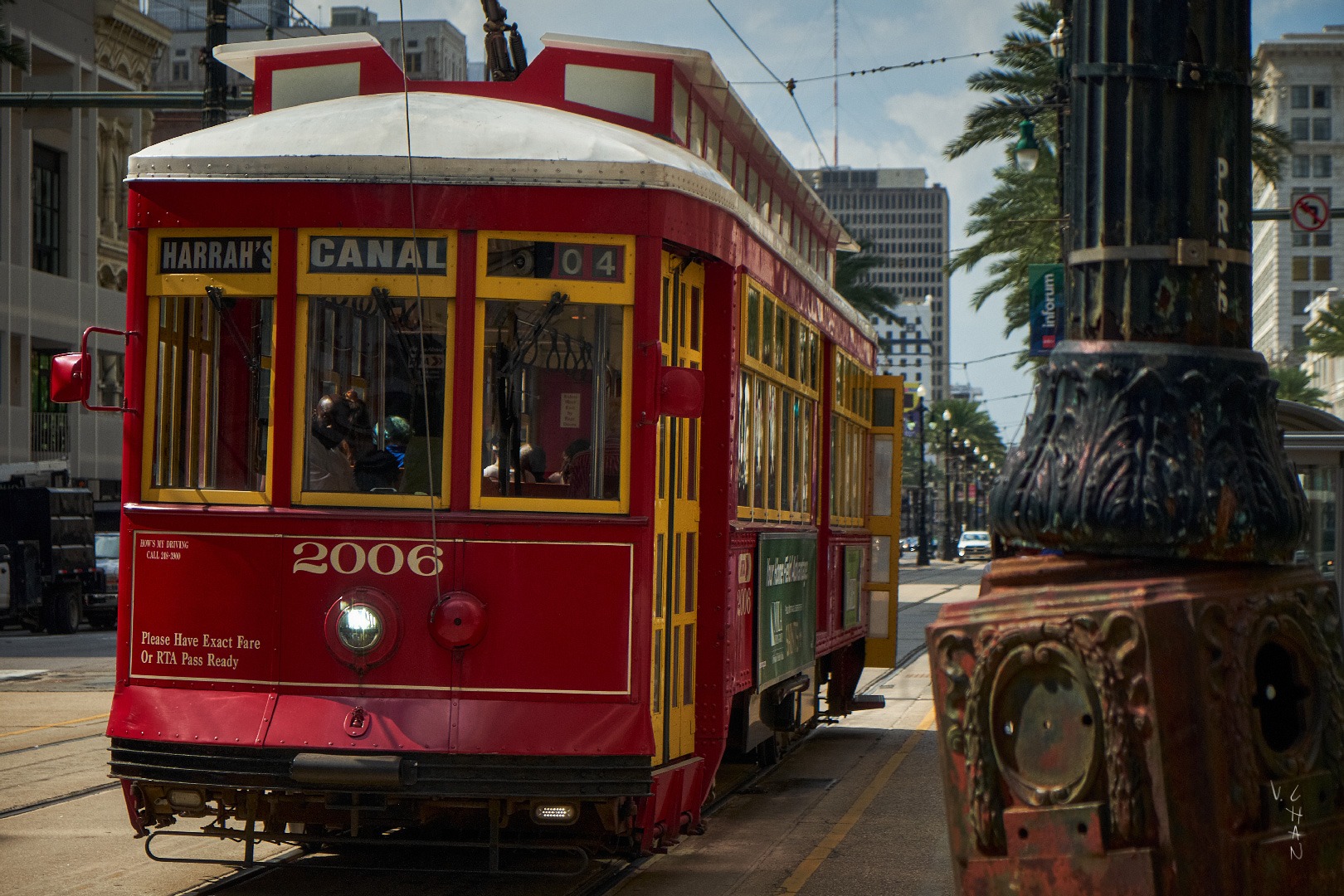 a red trolley car on a city street