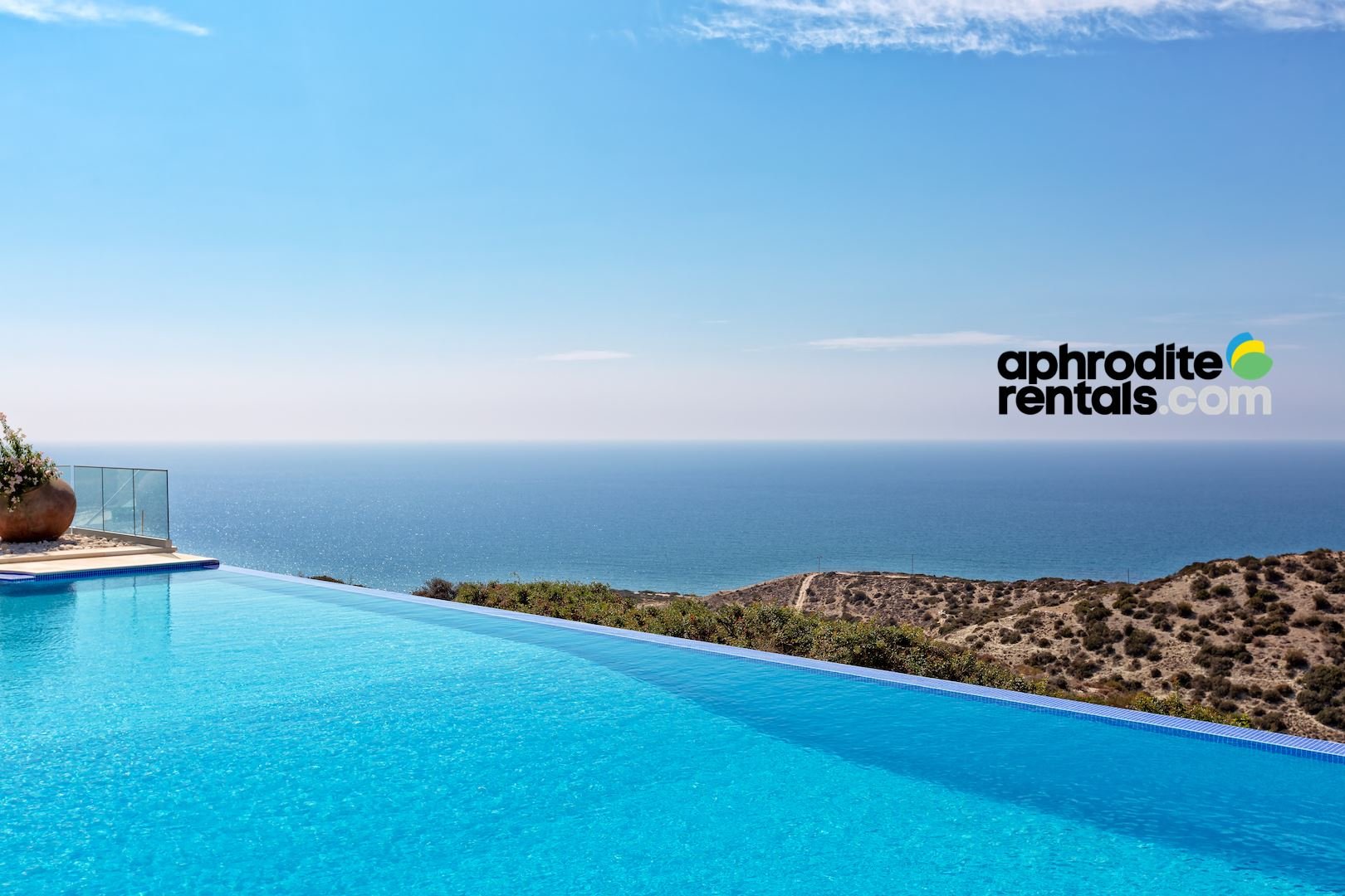 Aphoriterentals.com logo with pool and sea view