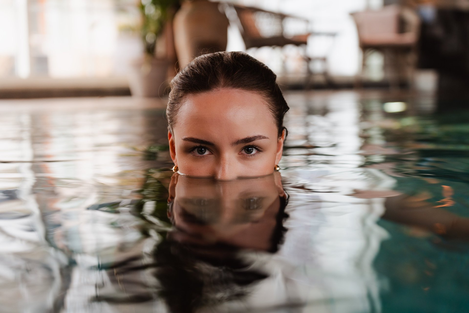 Women in pool with reflections from the water