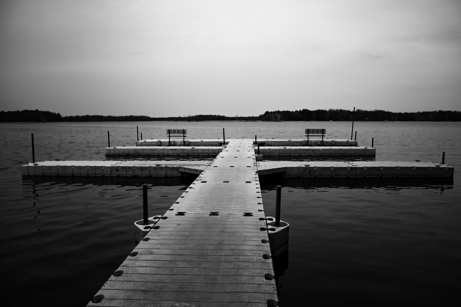 a dock with benches and benches in the water