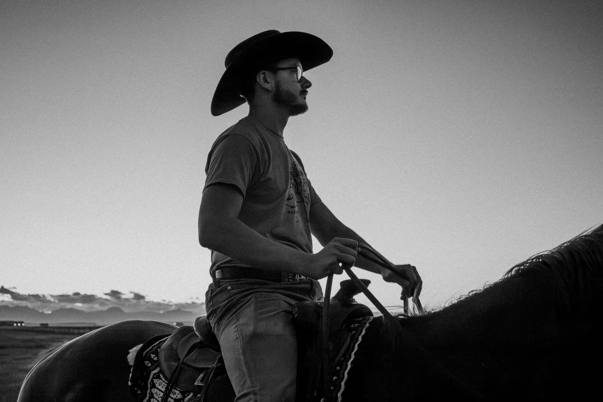 a man in a cowboy hat riding a horse