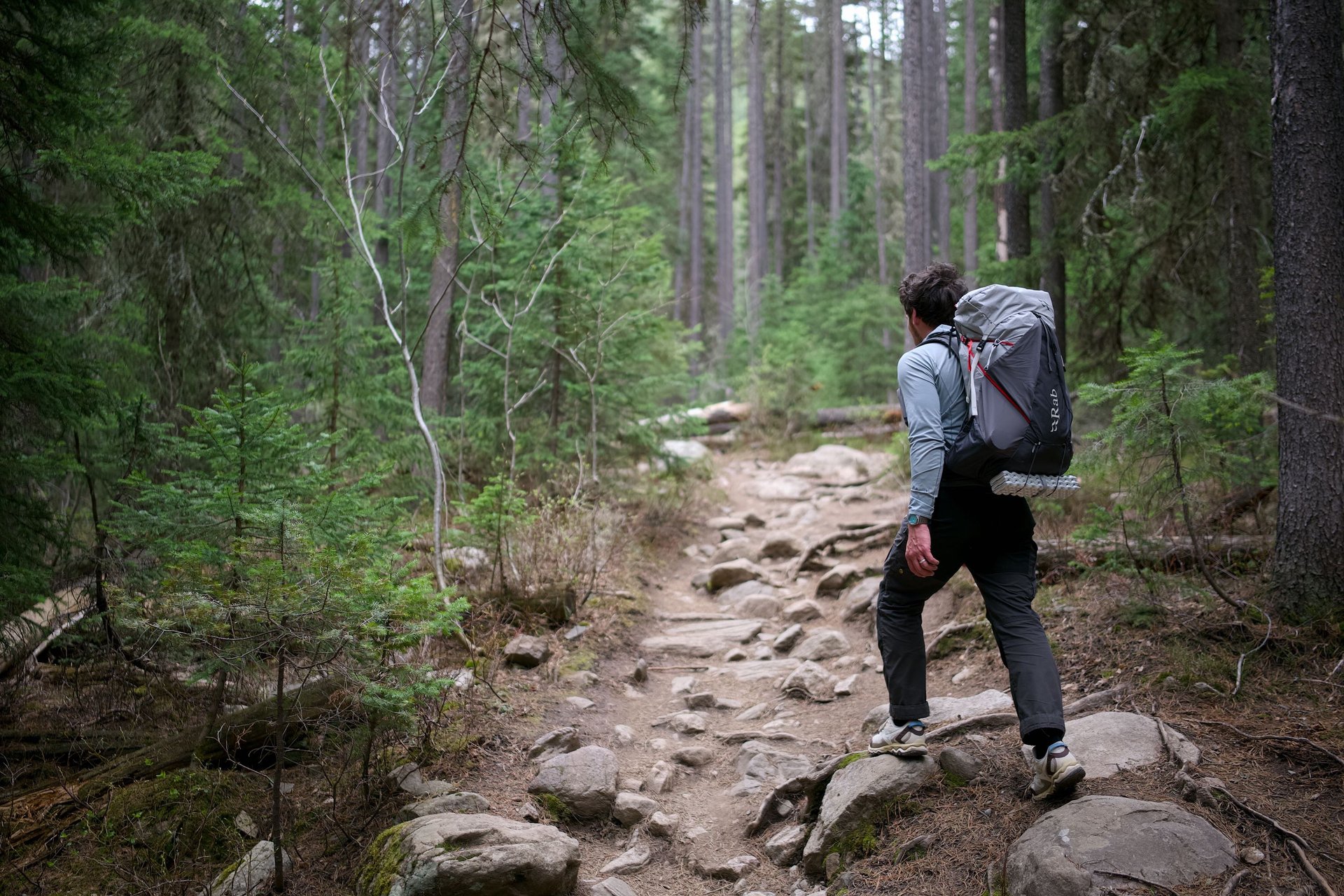 Man hiking with the Rab muon 50L backpack.