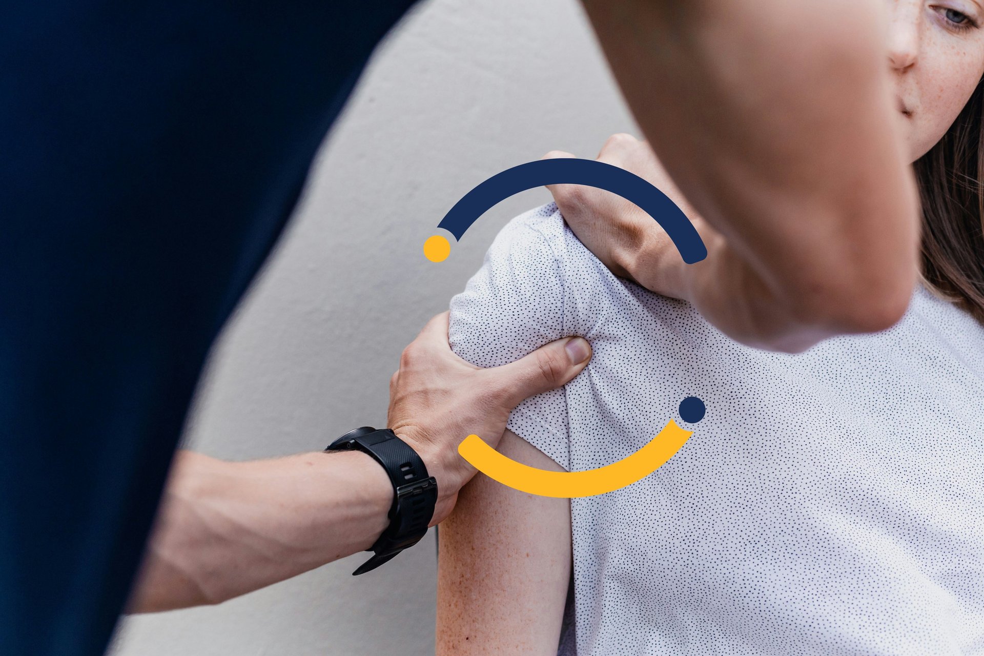 A physical therapist performing a shoulder mobilization adjustment on a female patient's joint.